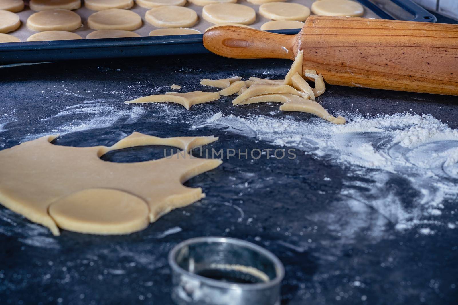 Rolling pin and kitchenware for making easter cookies on dark background.