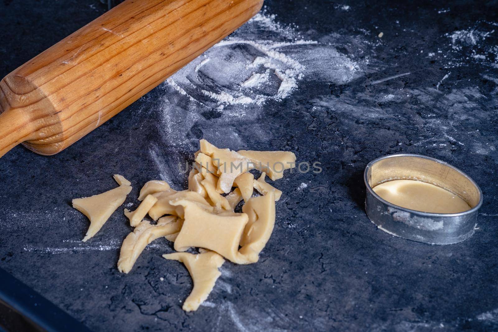 Rolling pin and kitchenware for making easter cookies on dark background.