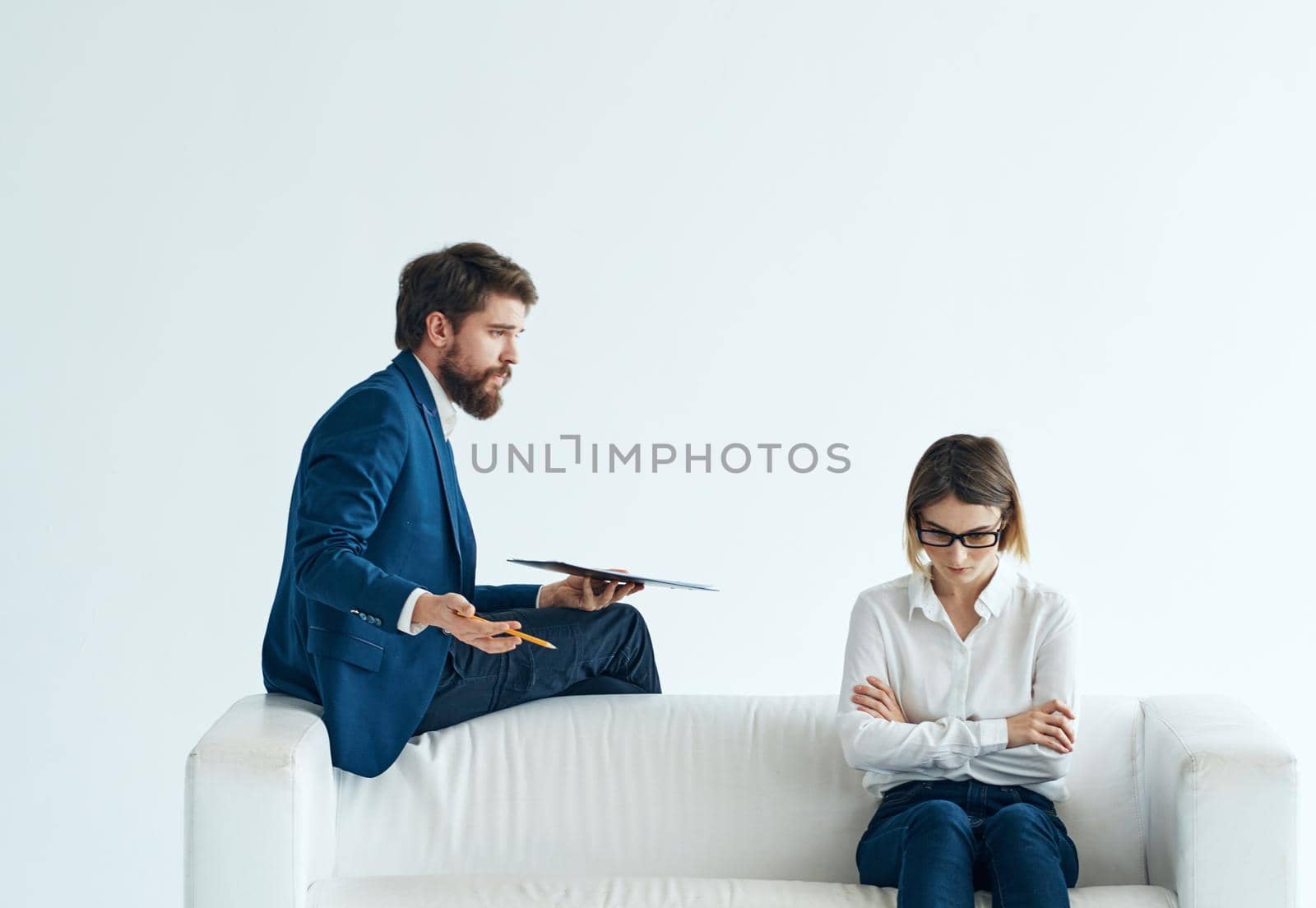 Work colleagues sit on the couch communicating lifestyle interior emotions. High quality photo