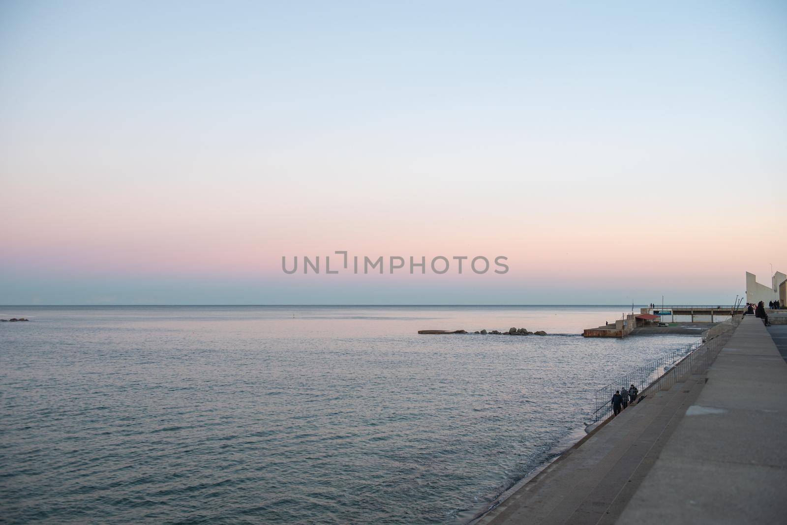 Barcelona, Spain - Febrary, 2021 - Sunset in Nova Icaria Beach in the Barcelona area on the Mediterranean on winter 2021