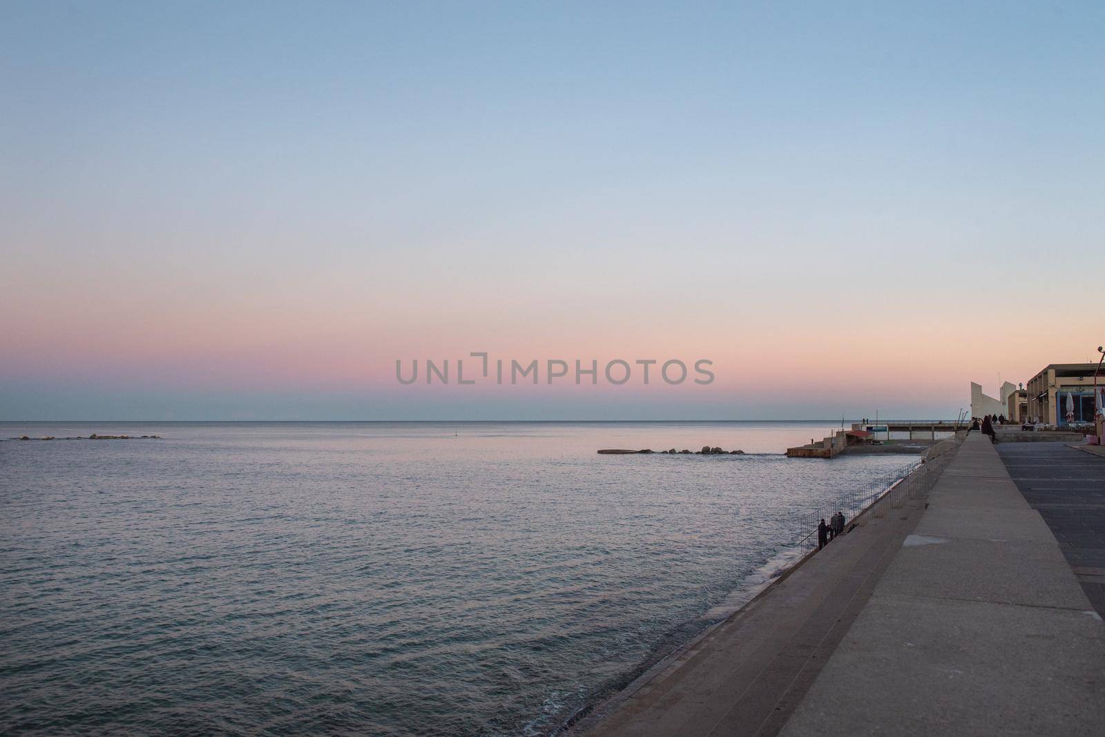 Barcelona, Spain - Febrary, 2021 - Sunset in Nova Icaria Beach in the Barcelona area on the Mediterranean on winter 2021