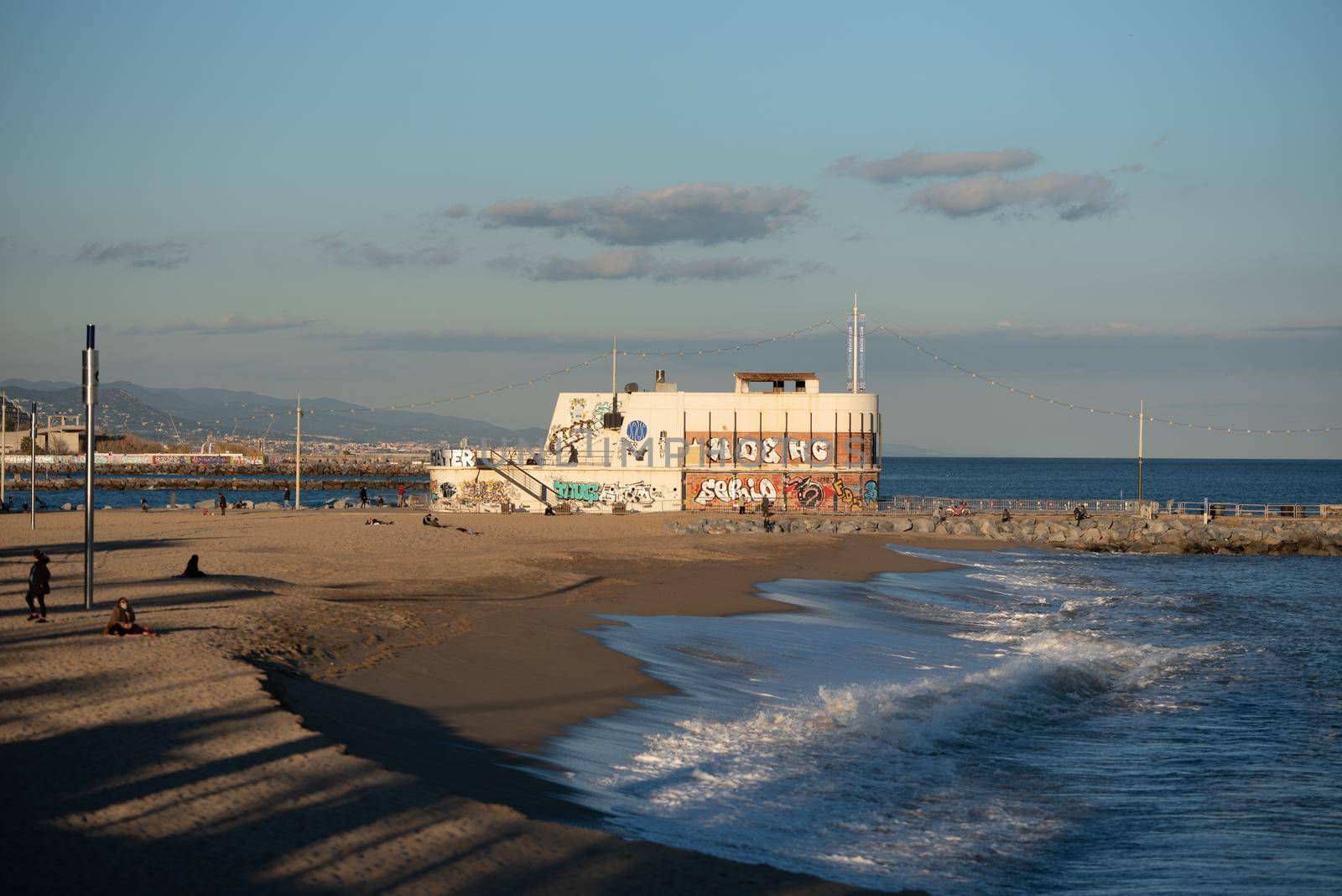 Barcelona, Spain: 2021 February 12: Mar Bella Beach on the Barcelona seafront at the time of Covid 19 in the winter of 2021.