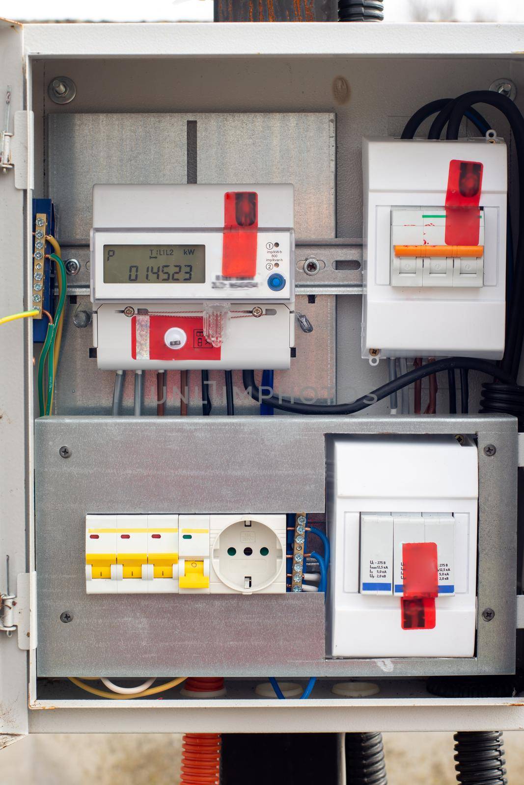 An introductory machine and an electric energy meter in a dashboard on a pole close-up