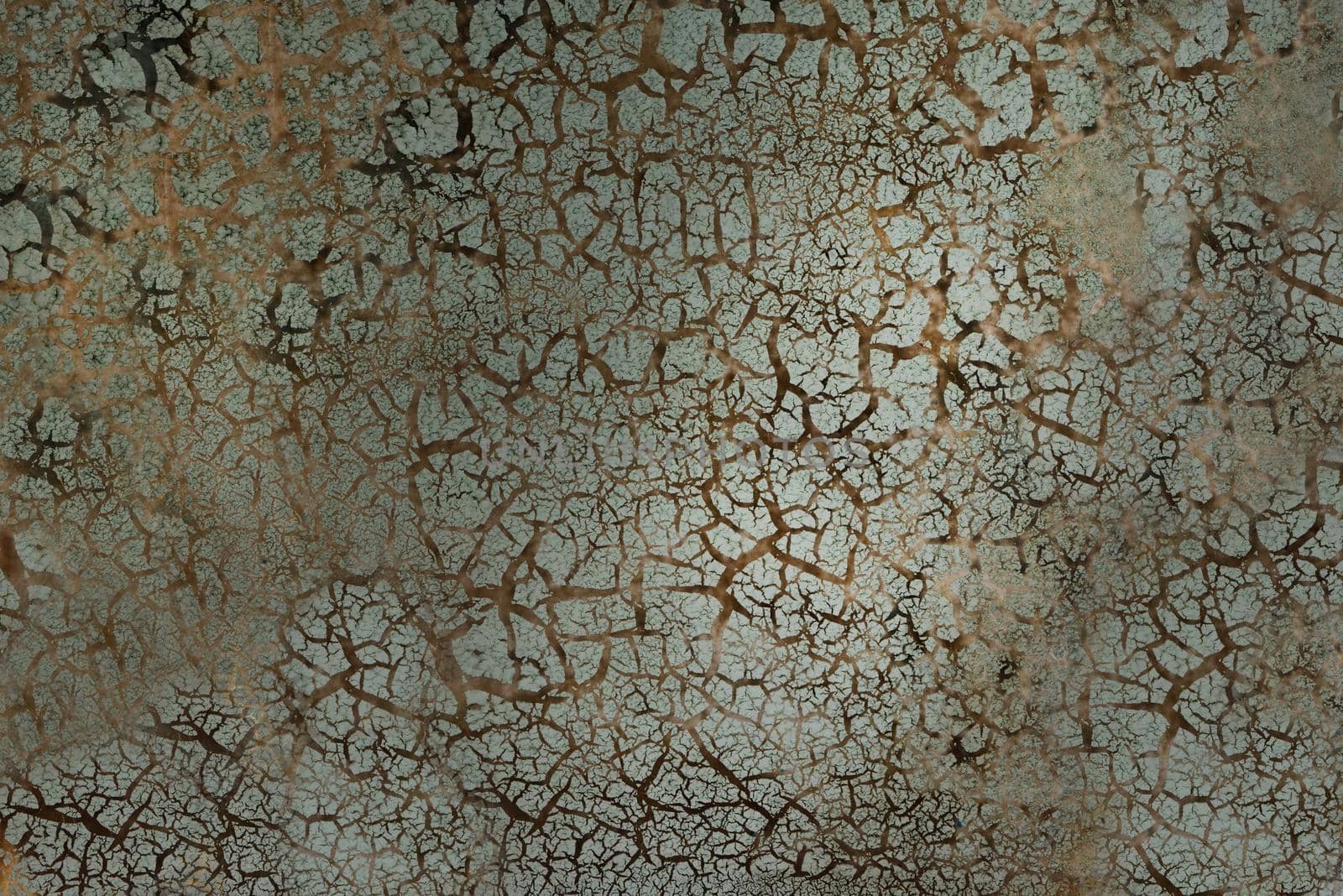 Outdoor green surface with numerous damages and cracks on the surface.Texture or background