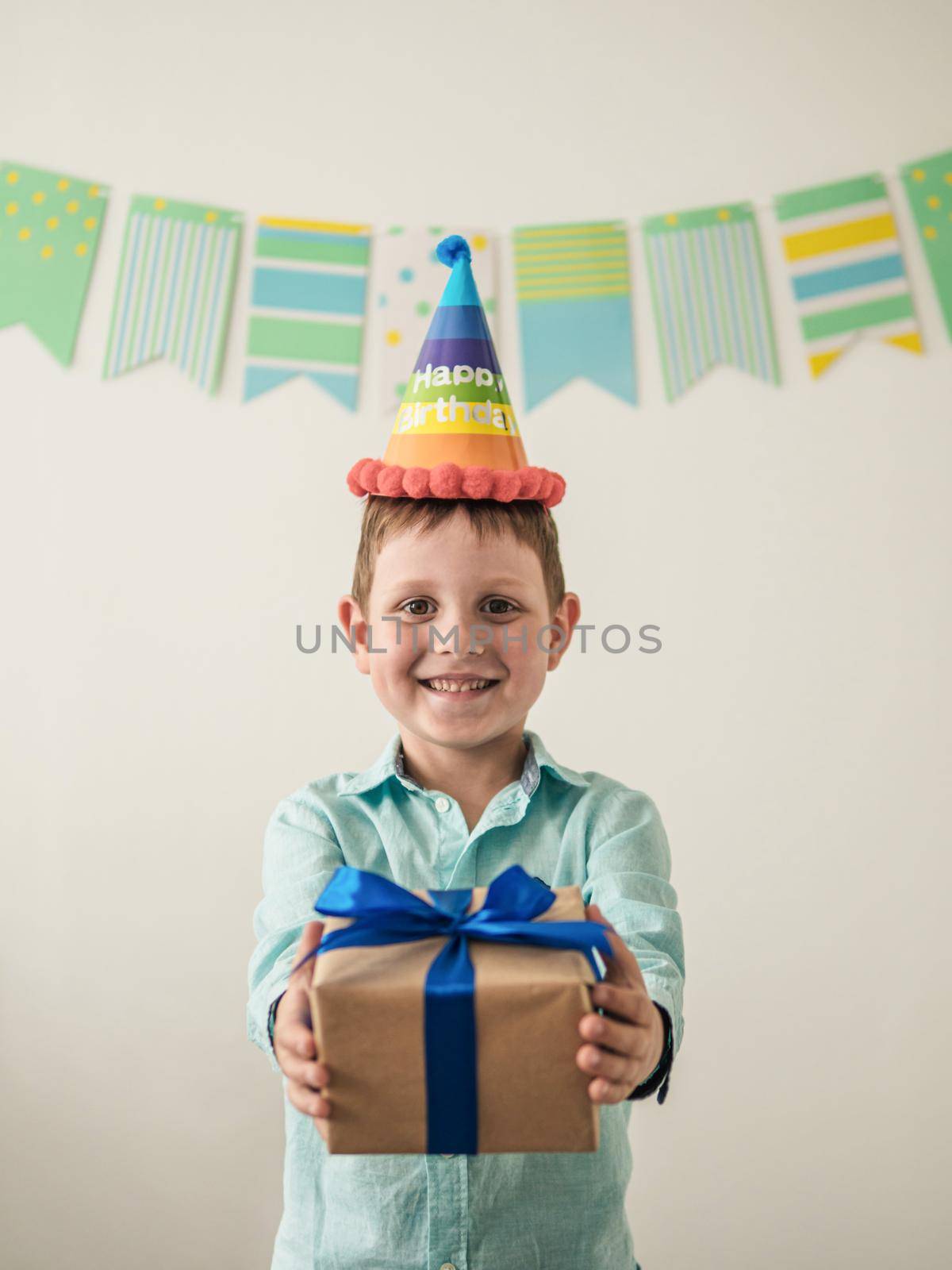 Five year old boy in his birthday hold gift box by fascinadora