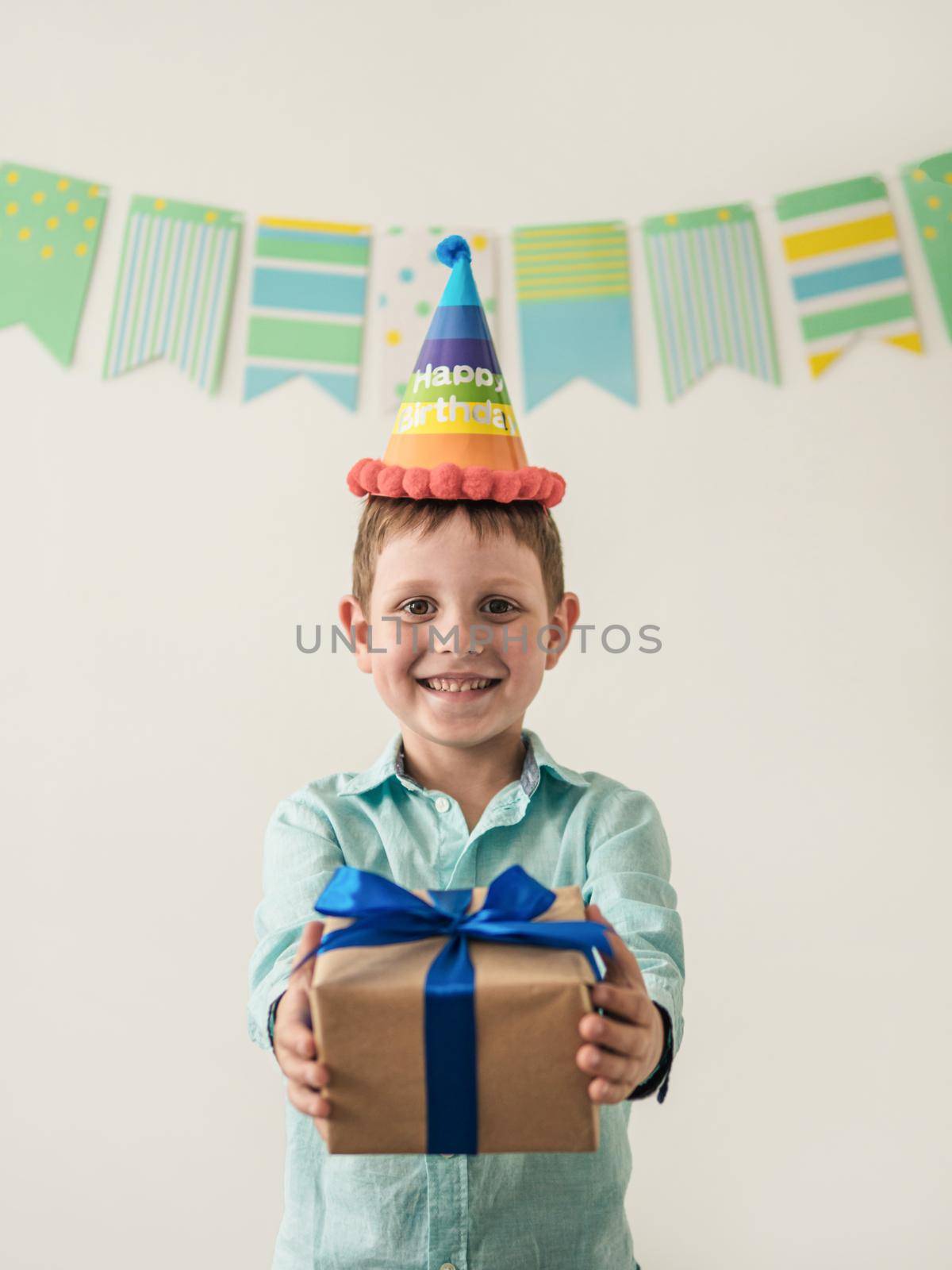 Five year old boy in his birthday hold gift box by fascinadora