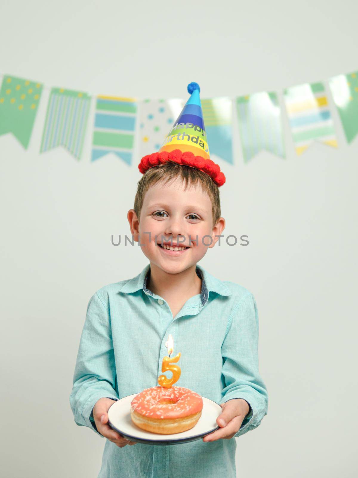 Birthday donut with candle in boy hands by fascinadora
