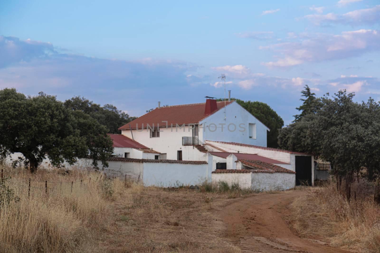 Farm in the middle of the countryside of the Sierra of cordoba Andalusia at sunset