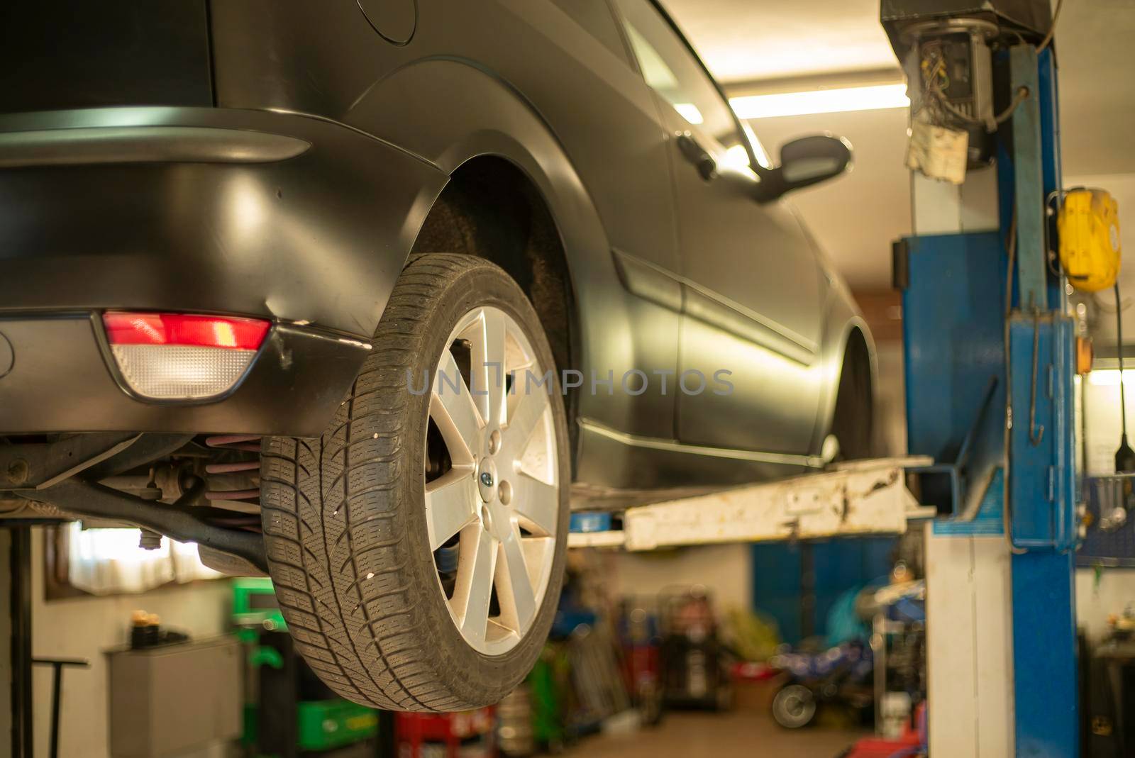 Automobile on overhead crane in the workshop for maintenance