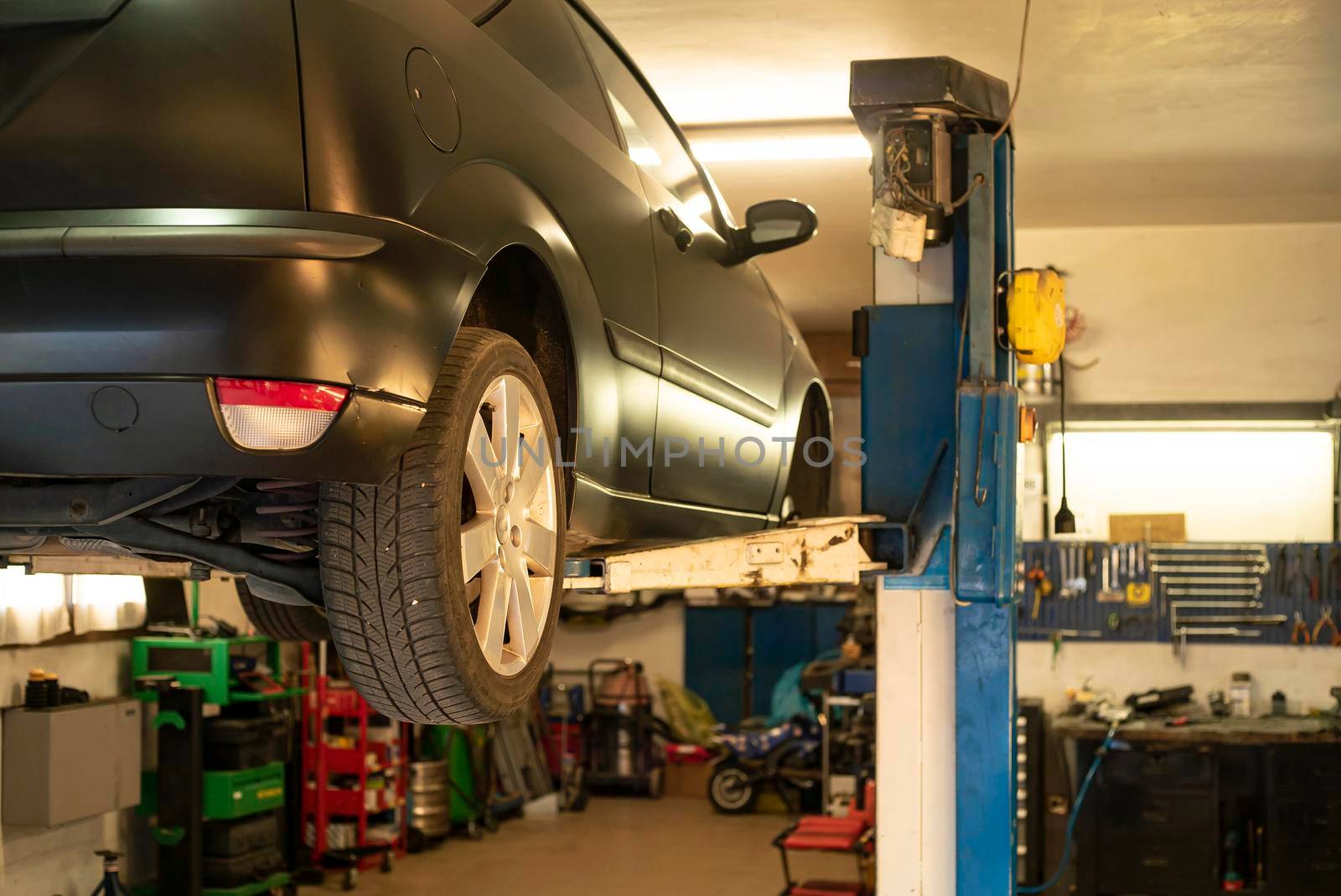 Automobile on overhead crane in the workshop for maintenance