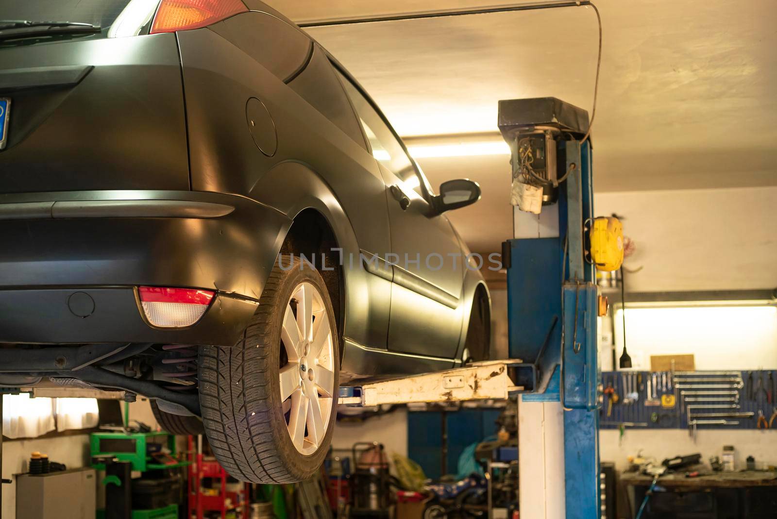 Automobile on overhead crane in the workshop for maintenance