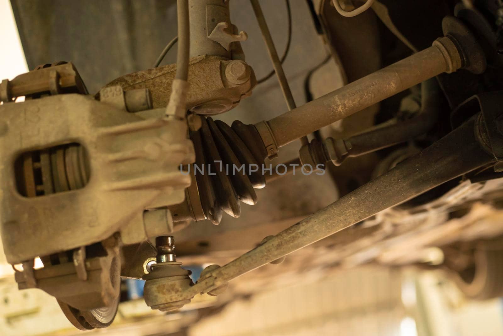 Detail of a drive shaft of the car while it is being repaired