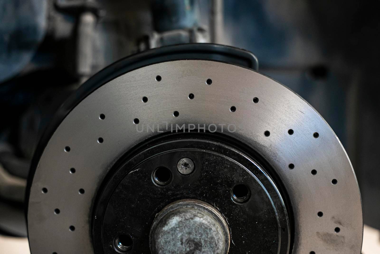 Detail of a perforated sports car disc brake, sport tuning spare parts