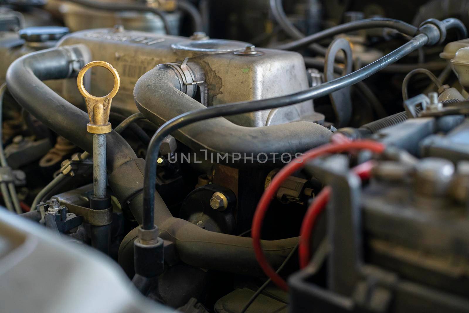 Detail of a used engine with mechanical parts on view inside a car