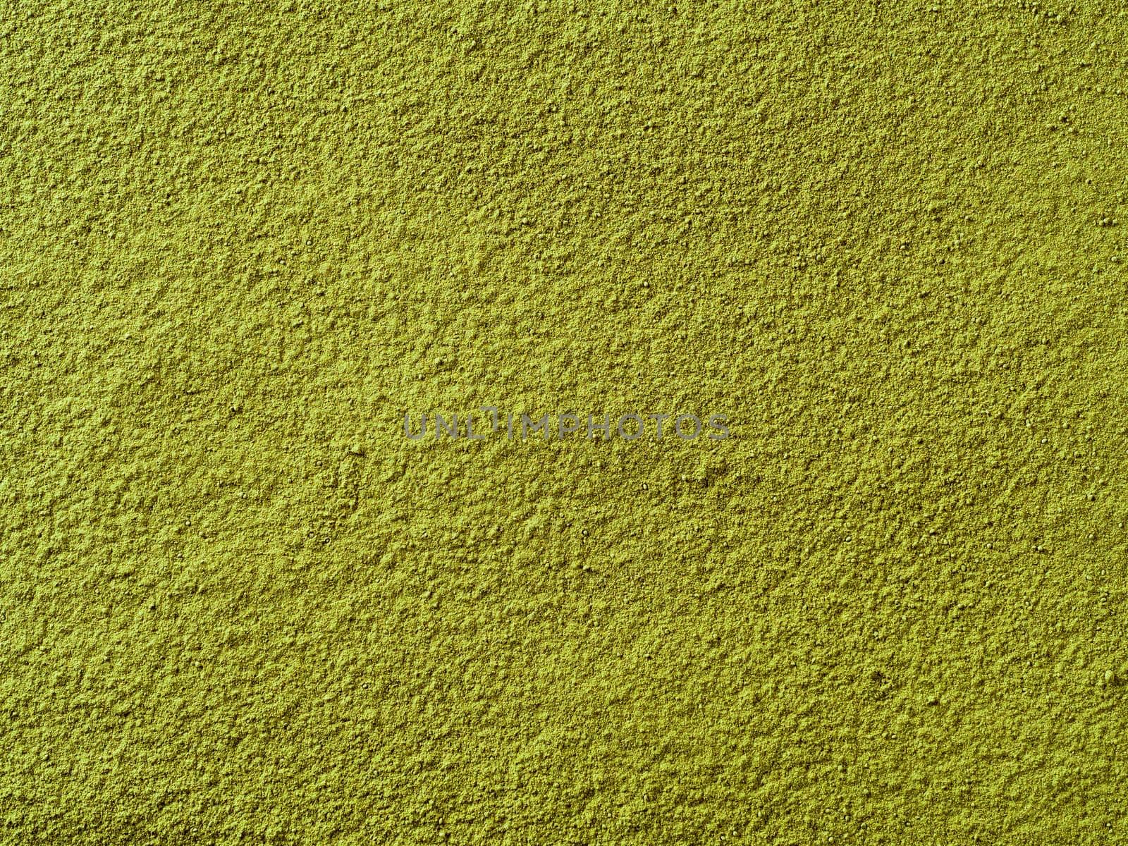 Powdered matcha green tea background. Close up. Dry green maccha powder tea with copy space for text or design