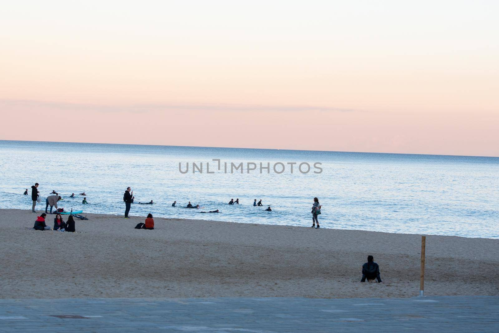 Barcelona, Spain: 2021 February 12: People walk along the Barcelona promenade in time of Covid 19 in winter 2021.