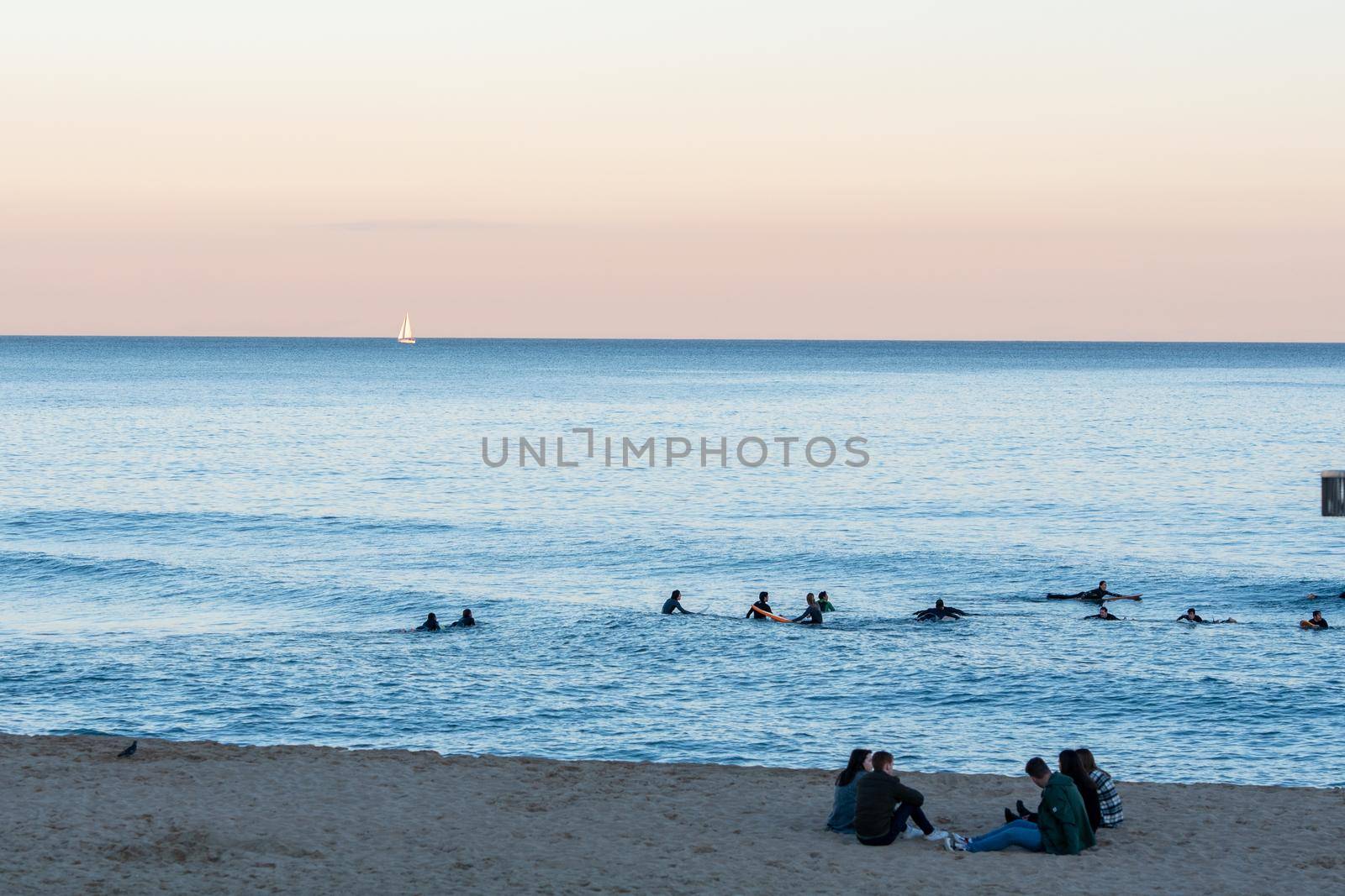 Barcelona, Spain: 2021 February 12: People walk along the Barcelona promenade in time of Covid 19 in winter 2021.
