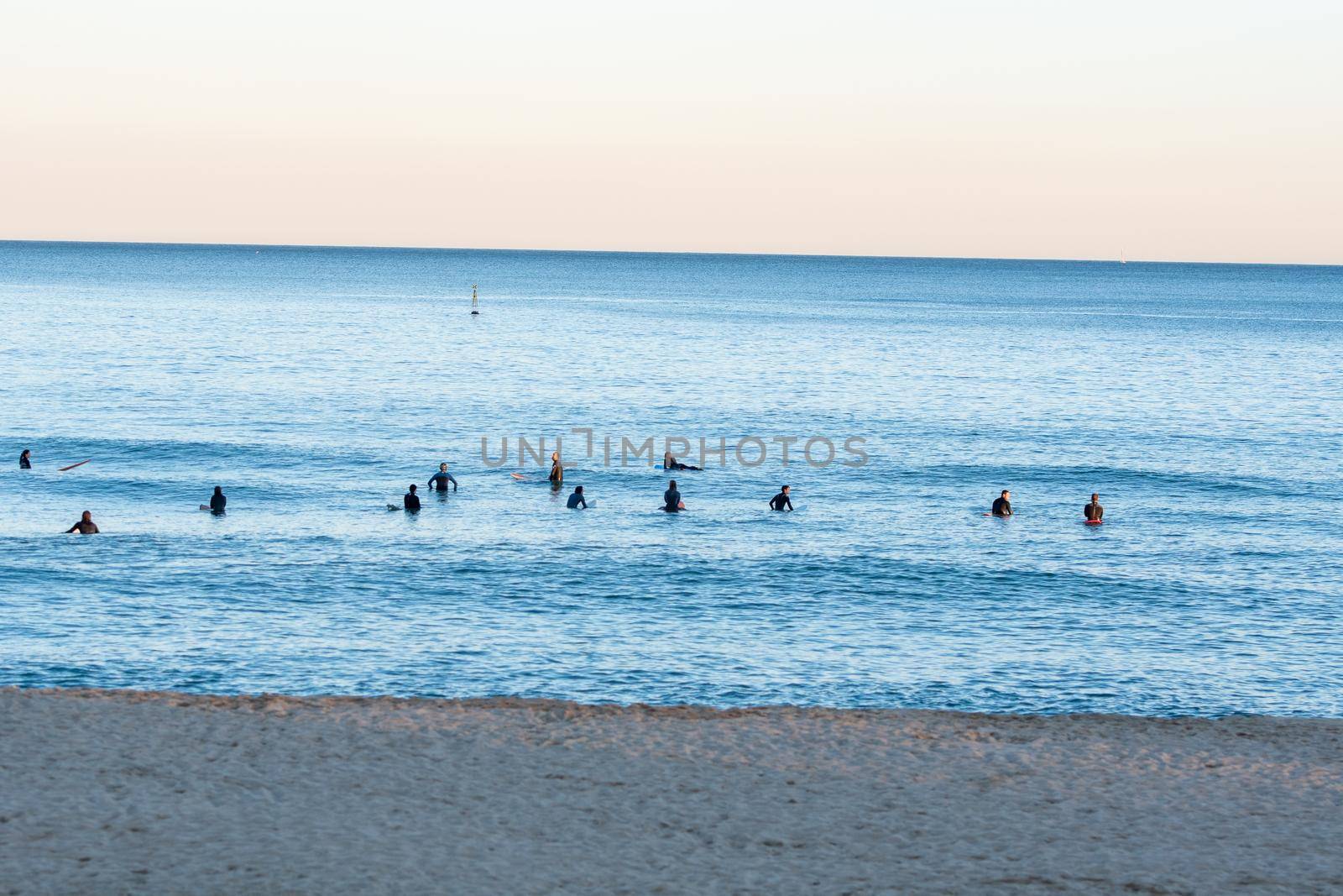 Barcelona, Spain: 2021 February 12: People walk along the Barcelona promenade in time of Covid 19 in winter 2021.