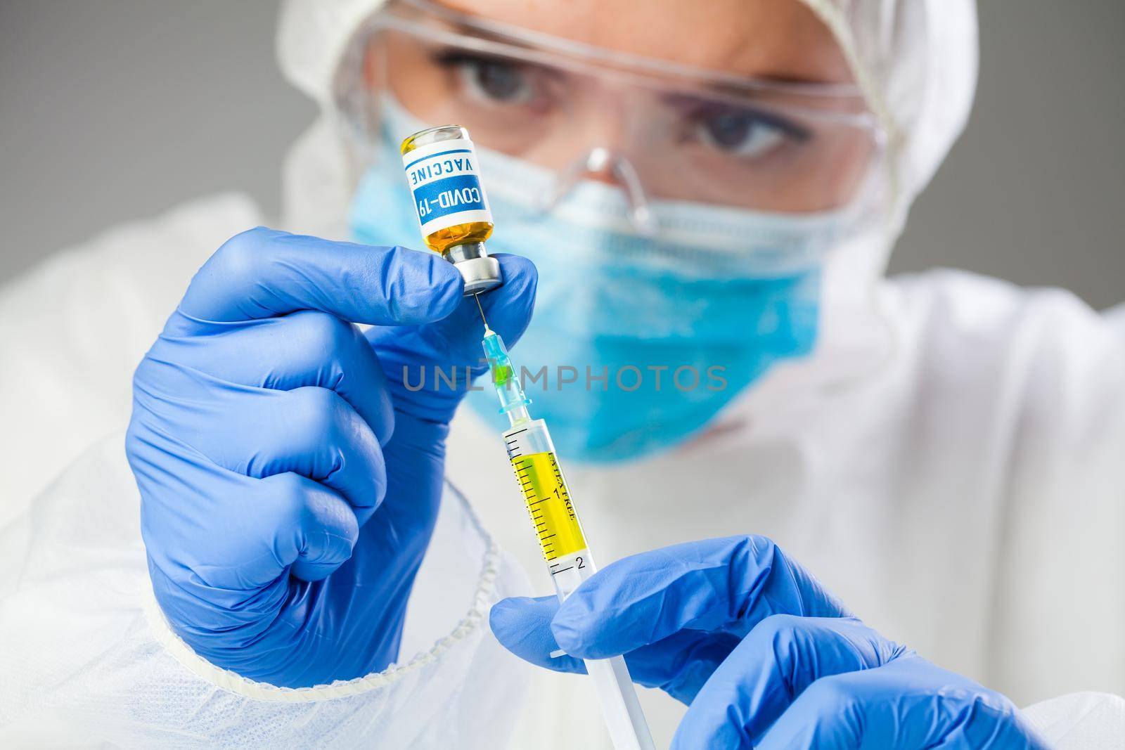 Medical scientist holding sample Coronavirus COVID-19 vaccine,injecting yellow liquid with syringe jab,global pandemic crisis,cure & treatment research,volunteer patients trial,research analysis hope