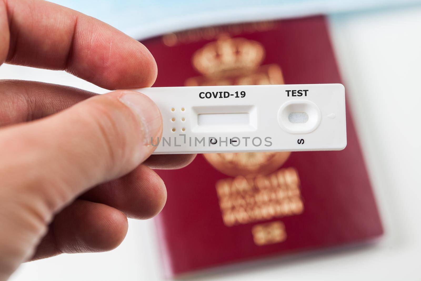 Person holding COVID-19 serological rapid diagnostic test,at home or point of care testing procedure,immunity passport or health passport concept,proof of immunization,risk free certificate document