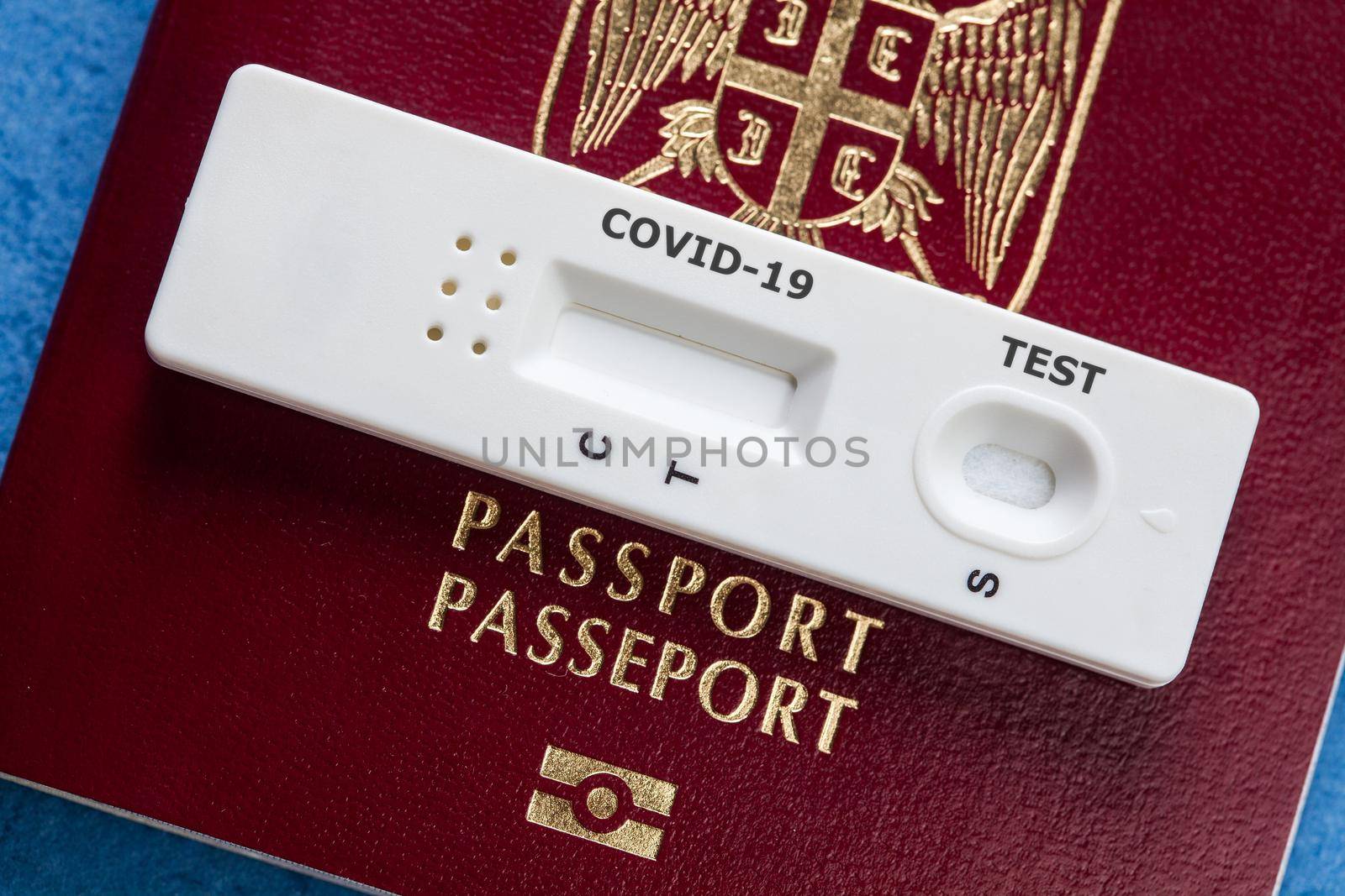 COVID-19 serological rapid diagnostic test on a Serbia passport,point of care testing procedure,immunity passport or health passport concept,risk free certificate as proof that patient is convalescent