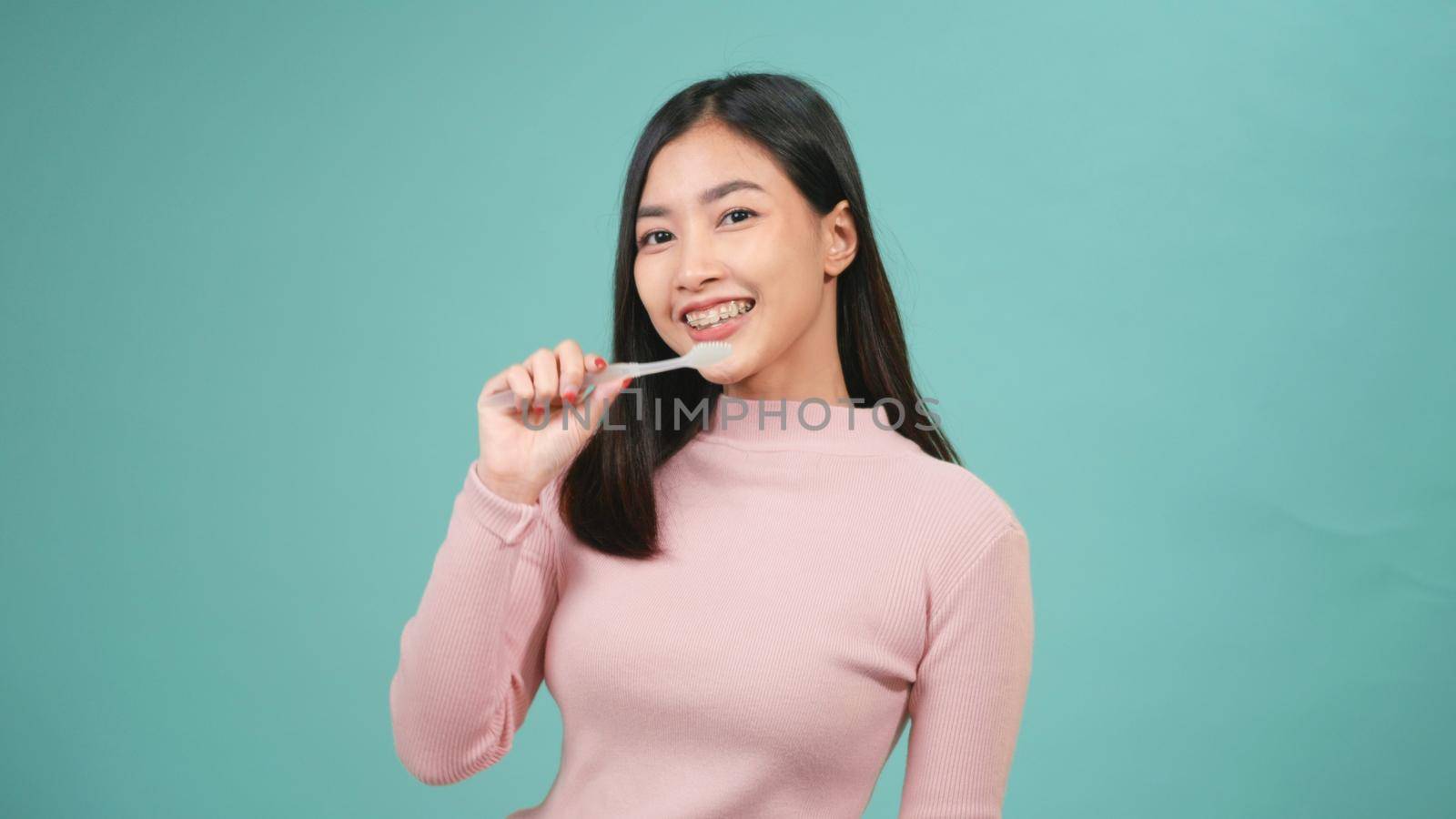 woman smile toothbrush instead microphone dancing by Sorapop