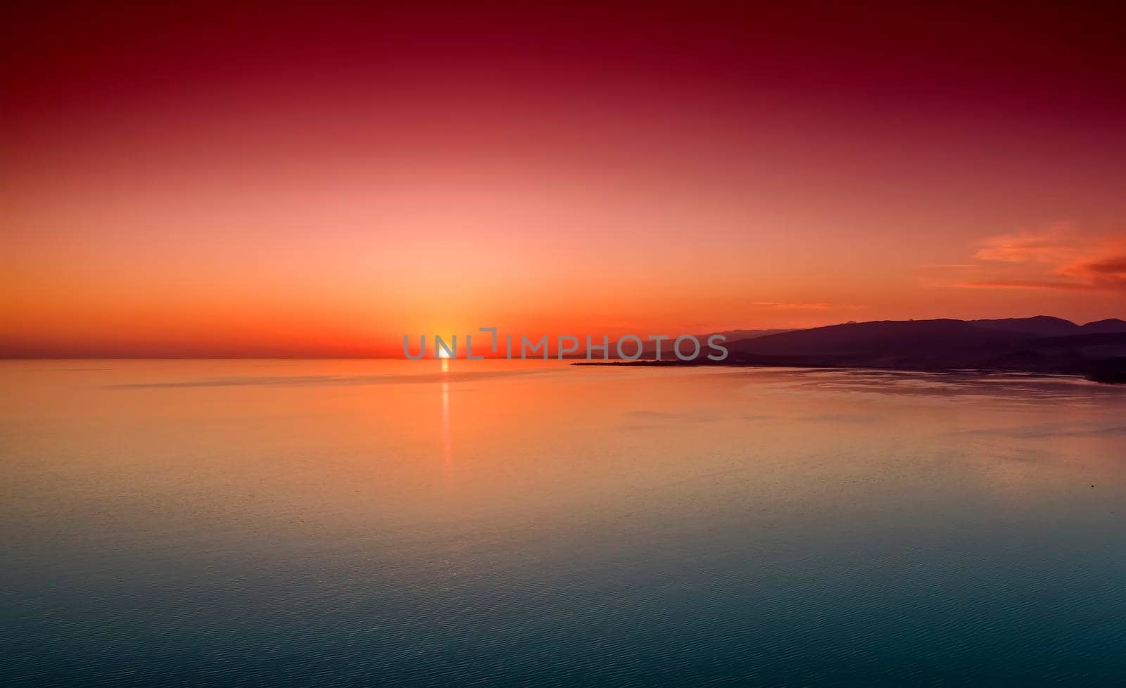 Beautiful bright sunset over the calm sea from a bird's eye view