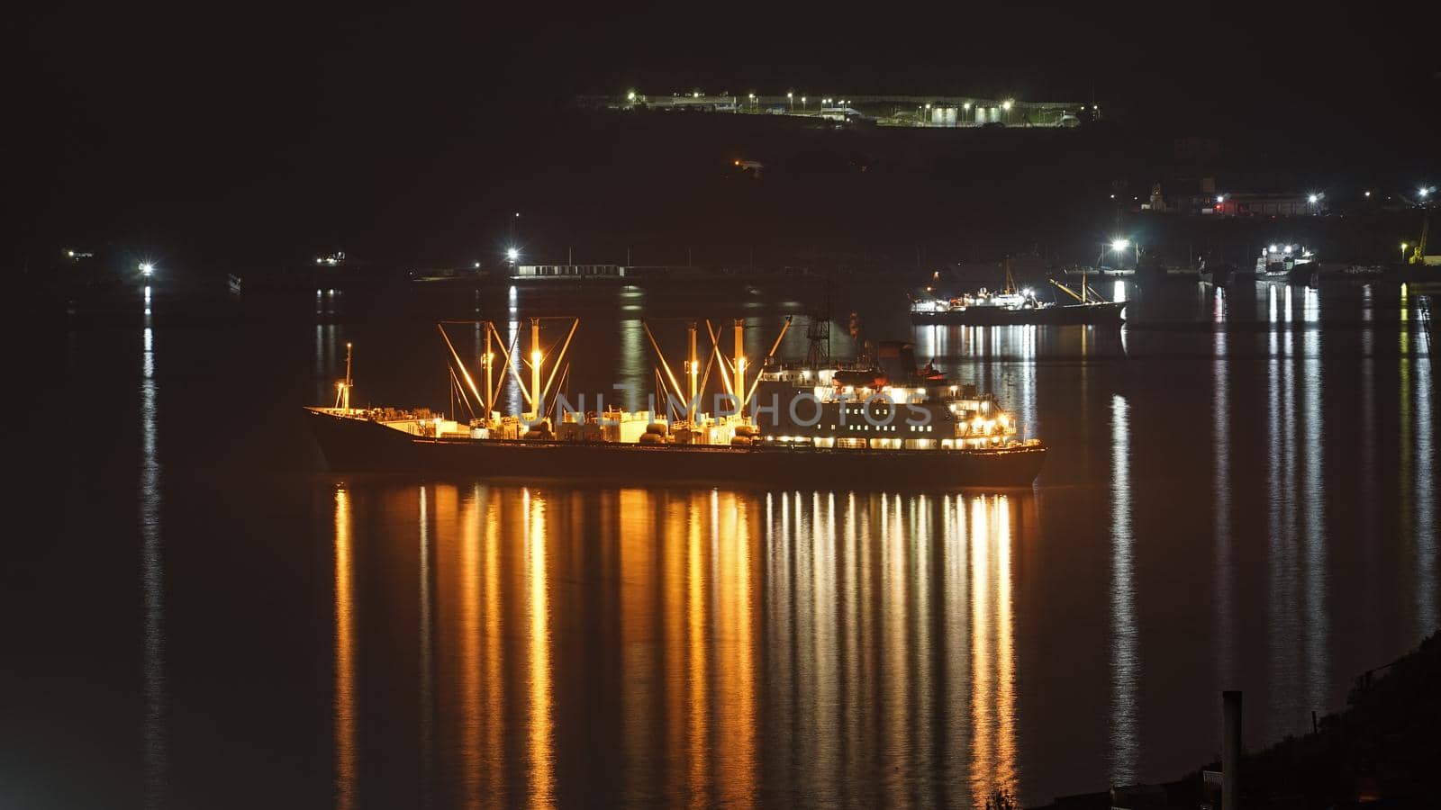 Night landscape with a fishing boat on the background of the sea. Vladivostok, Russia
