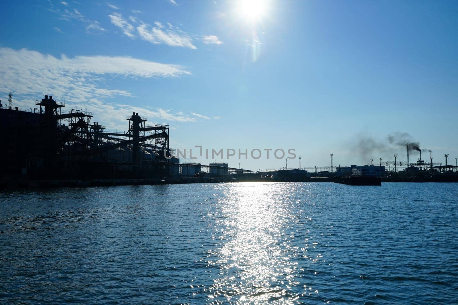 Silhouette of industrial structures in the background of the sea