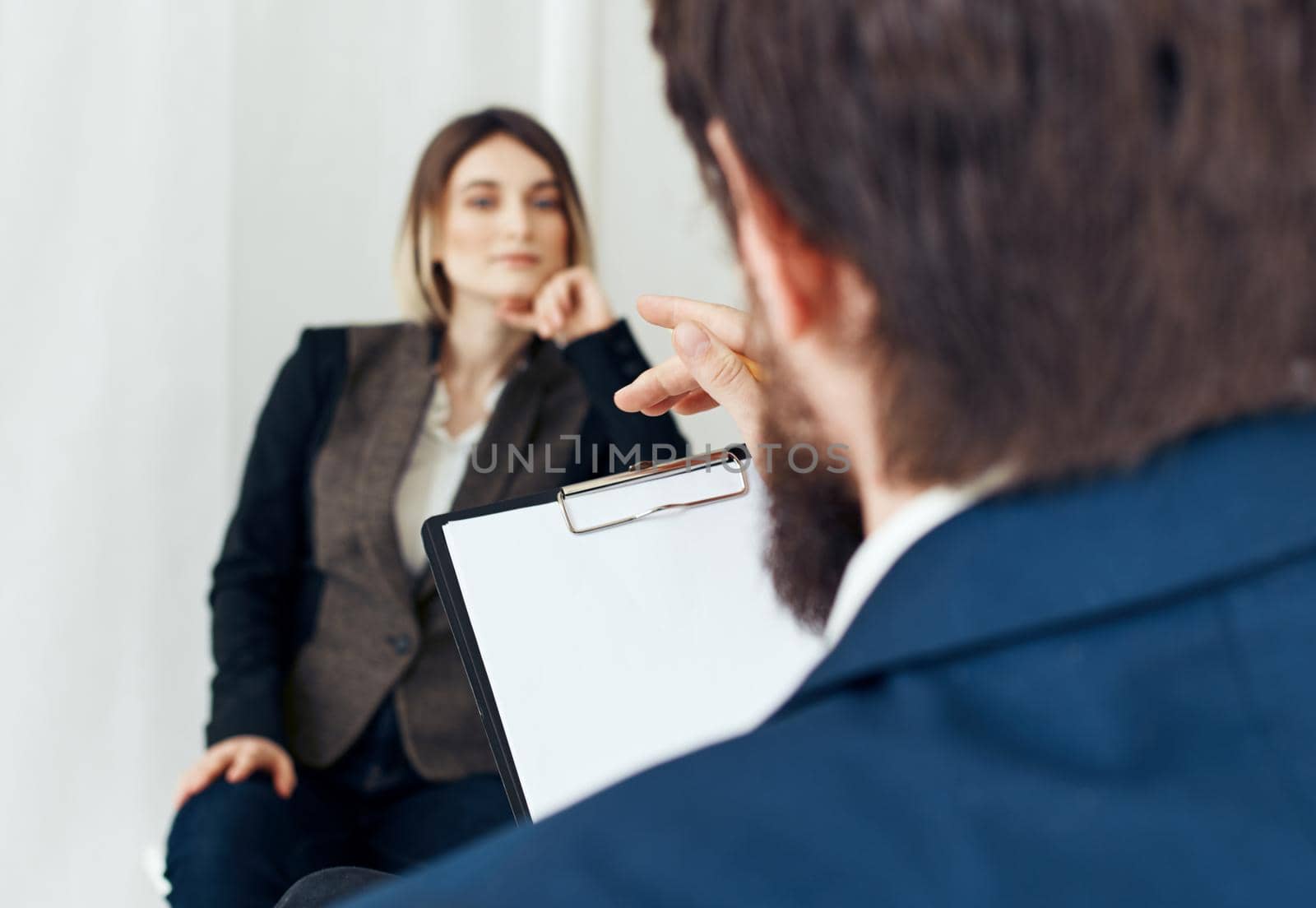 A man communicates with a woman and documents are in the hands of a psychologist at a doctor's appointment. High quality photo