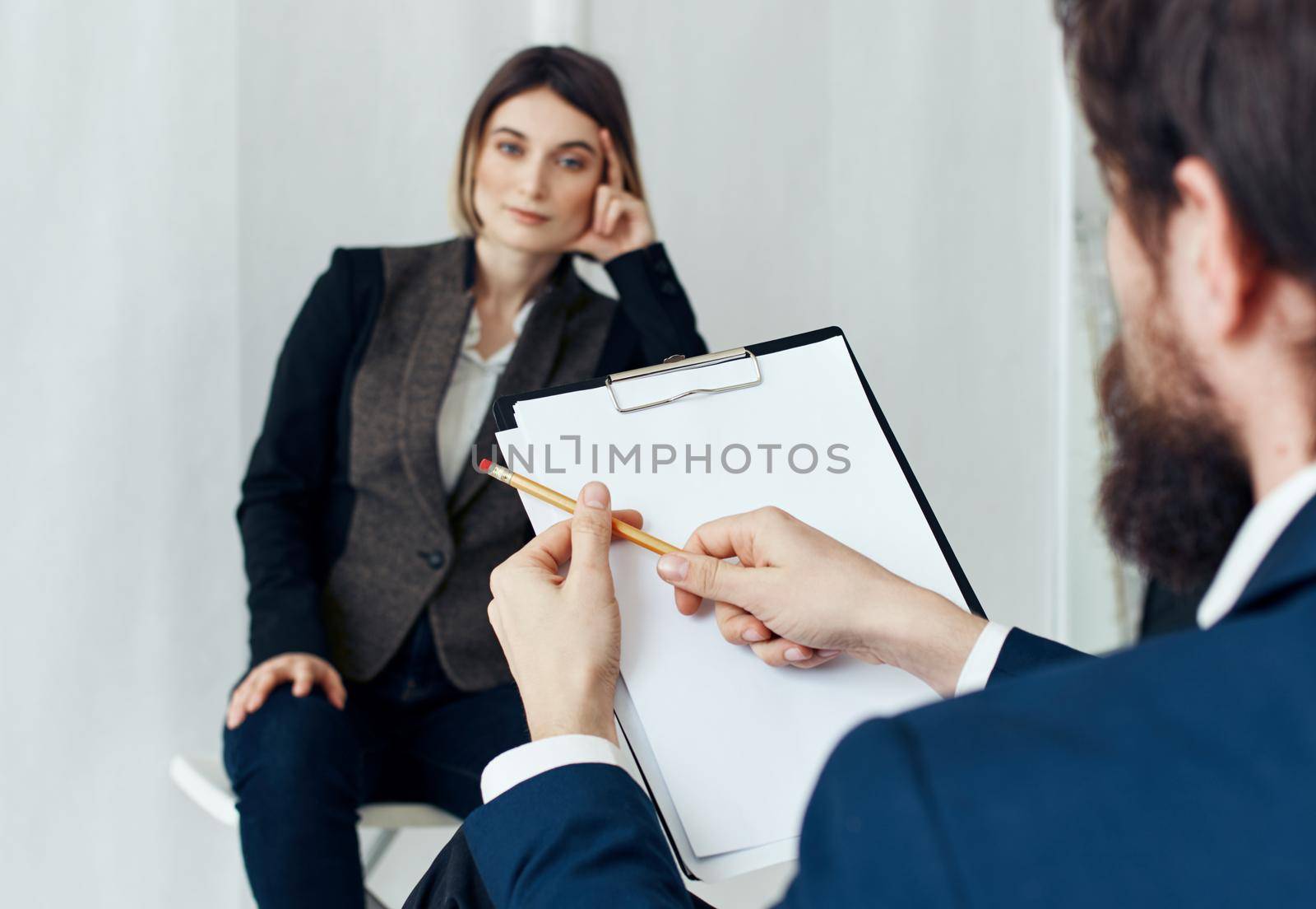 Woman for job interview and man with documents in the foreground. High quality photo