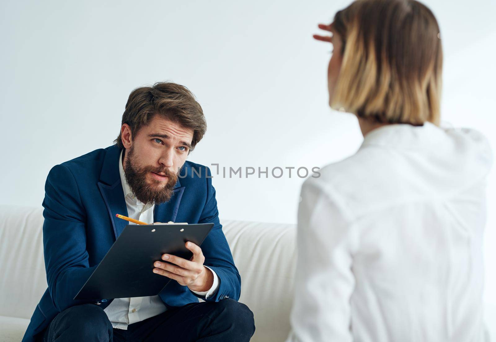 Man and woman sitting on the couch teamwork communication office. High quality photo