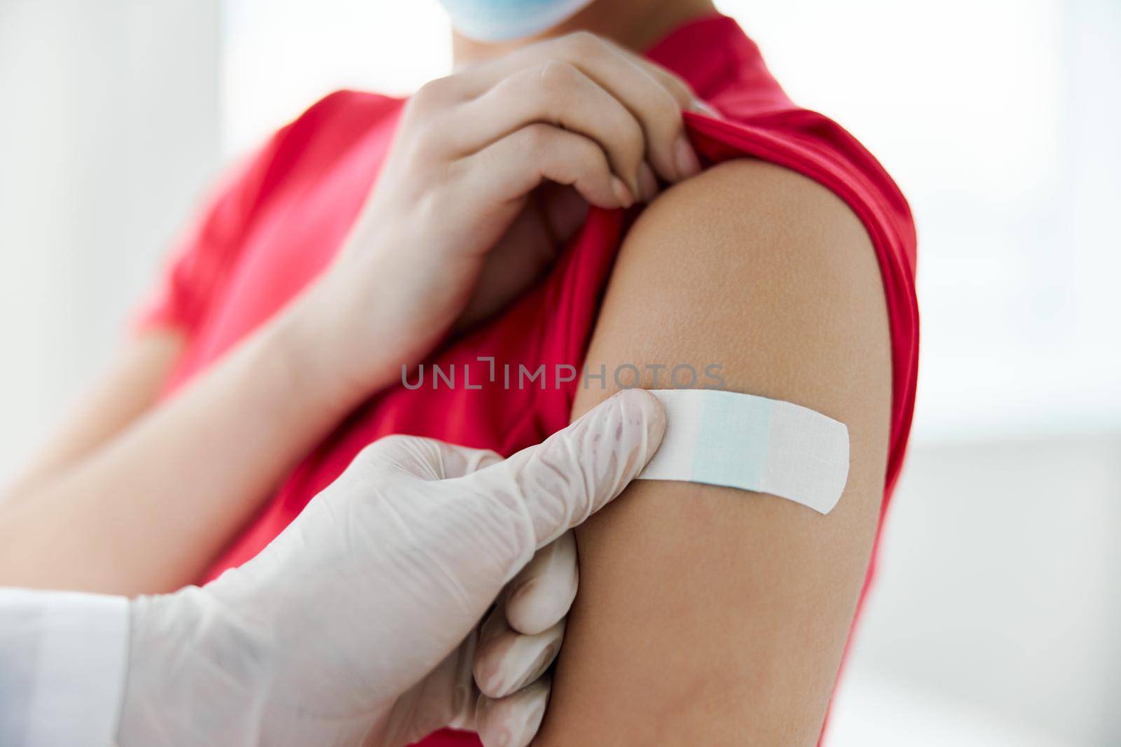 the doctor seals the hand with adhesive tape after the injection of health. High quality photo