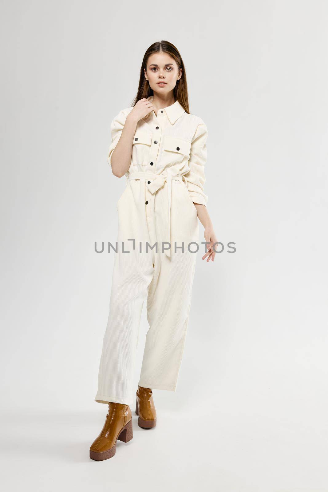 pretty woman in white suit trendy brown full length boots by SHOTPRIME