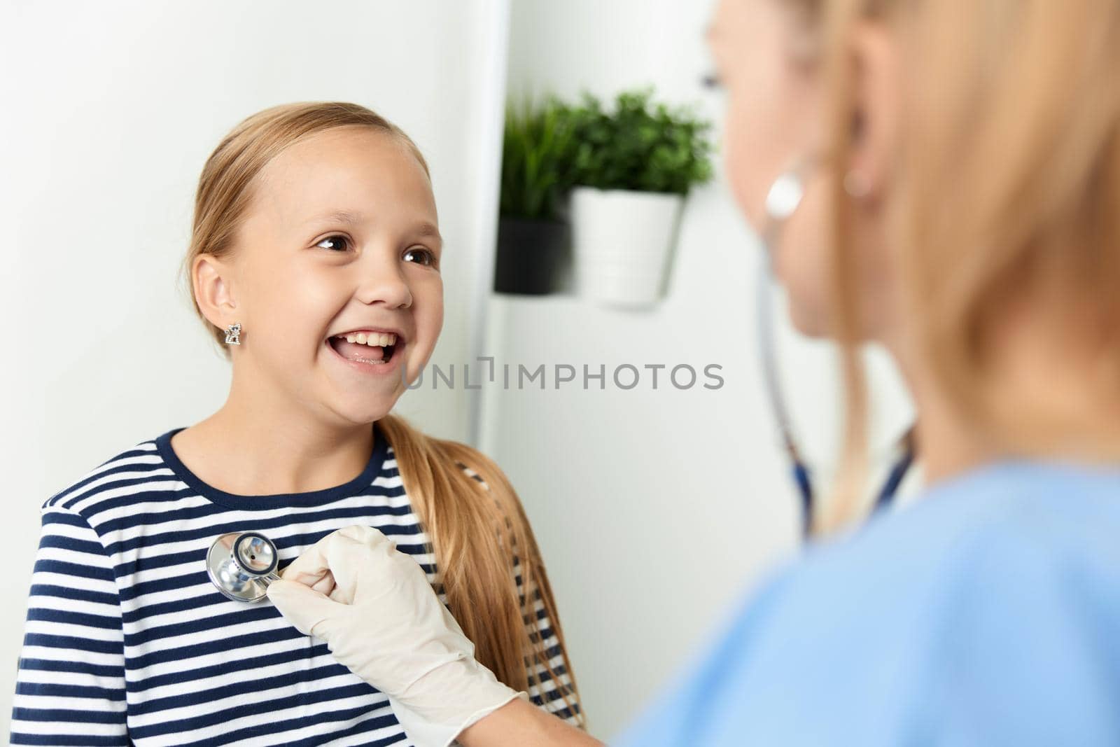 funny little girl in the hospital examination treatment. High quality photo