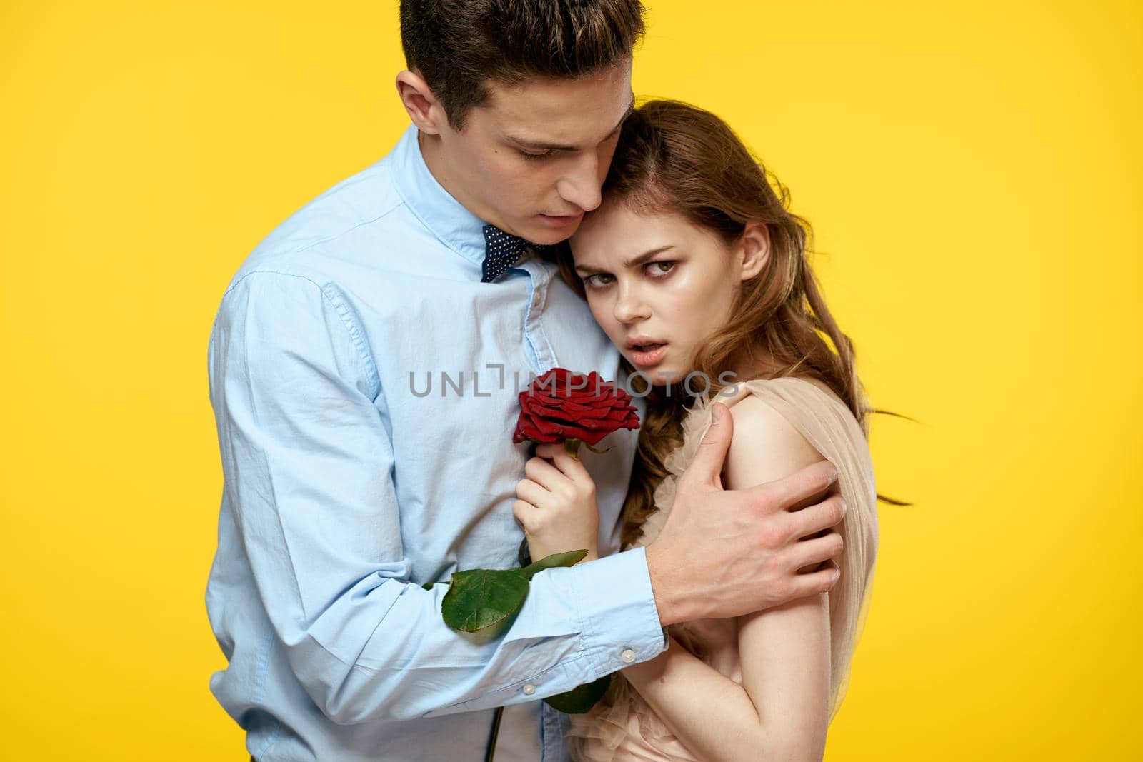 Young couple rose date glamor luxury yellow background. High quality photo