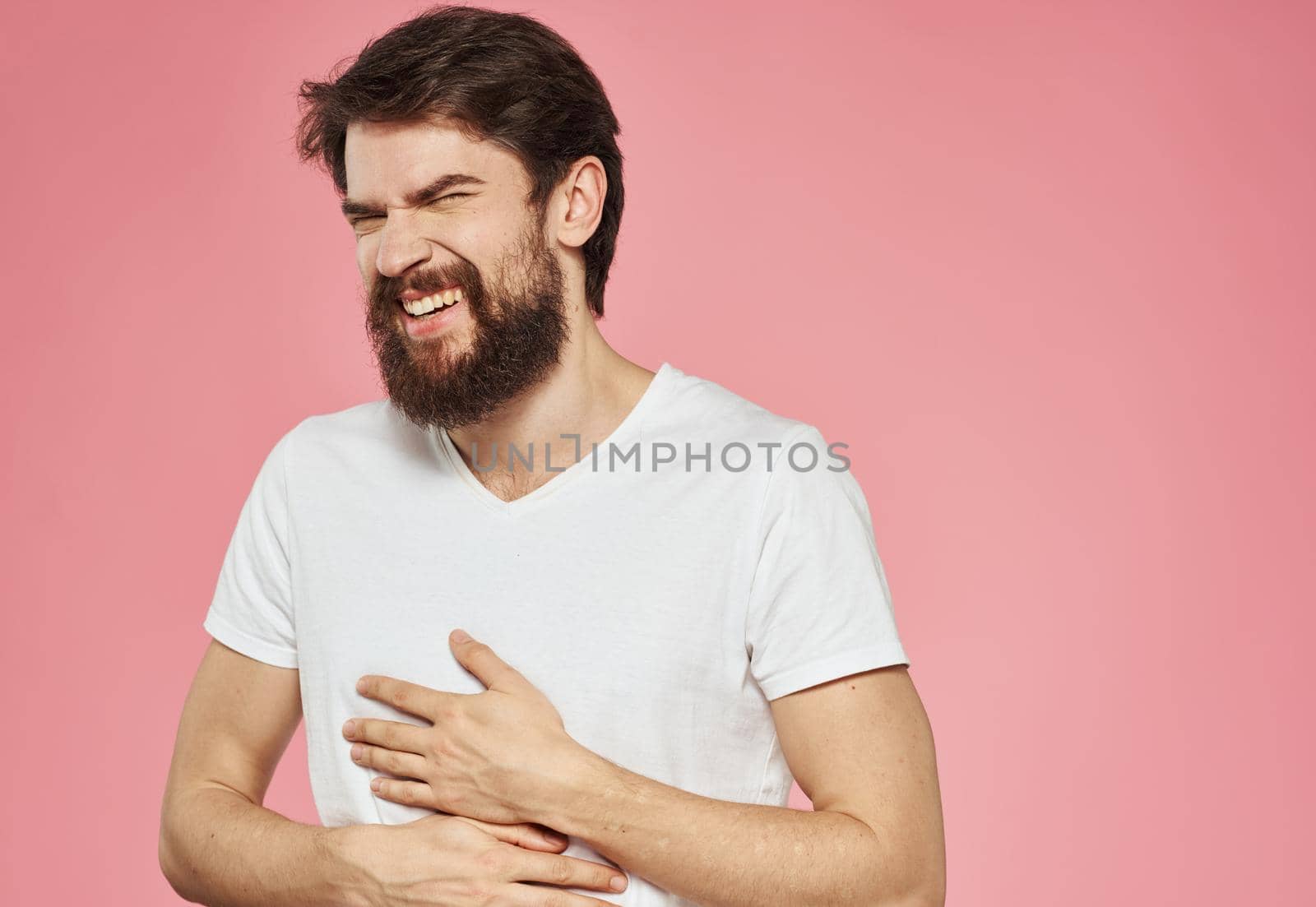 Emotional man gesturing with his hands on a pink background cropped view by SHOTPRIME