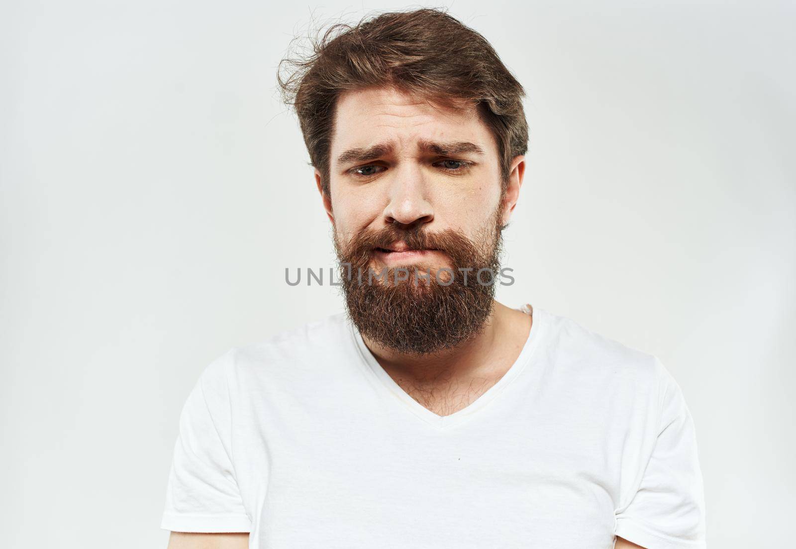 emotional man with beard puzzled look on light background by SHOTPRIME
