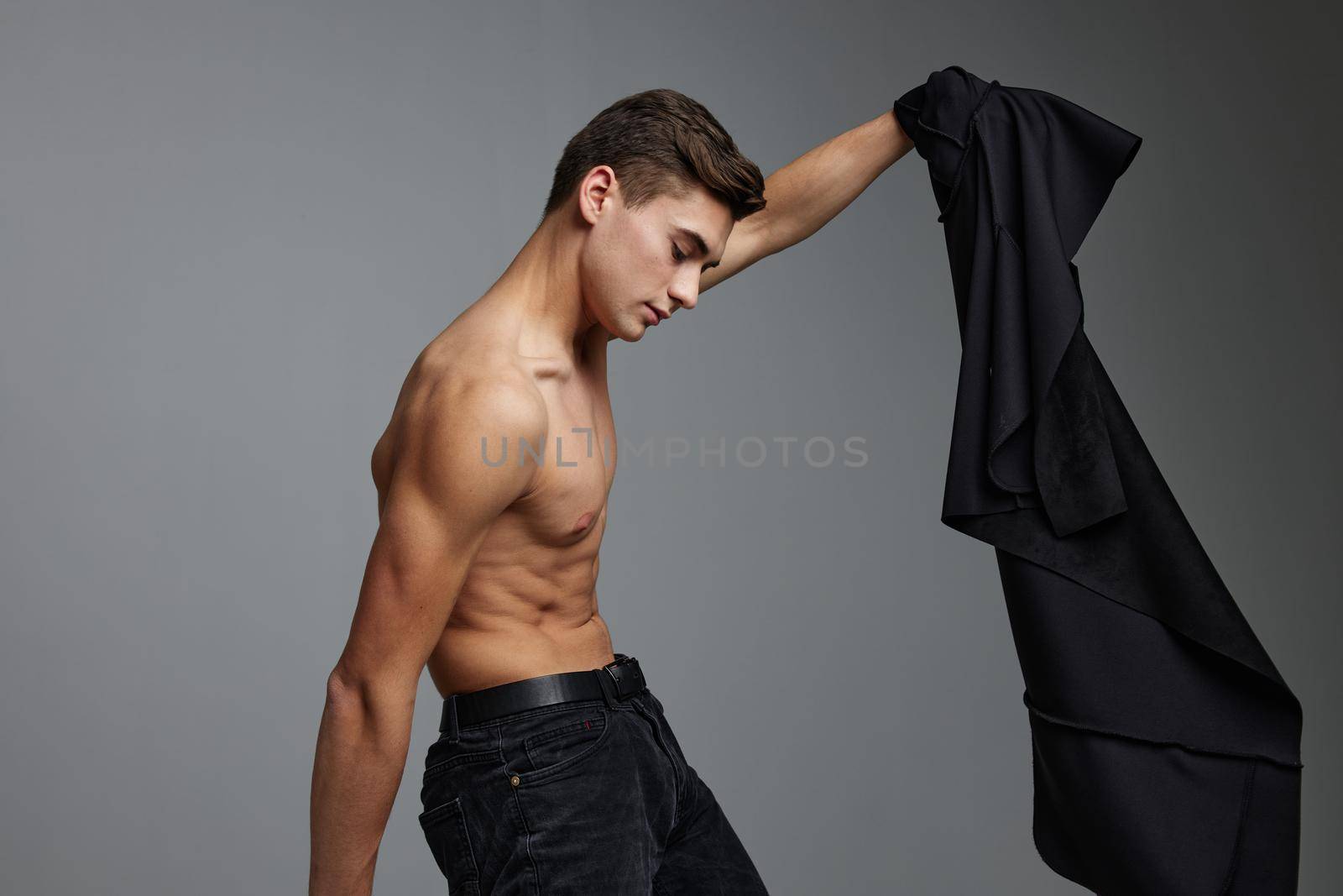 handsome man muscular torso black jacket models attractive look. High quality photo