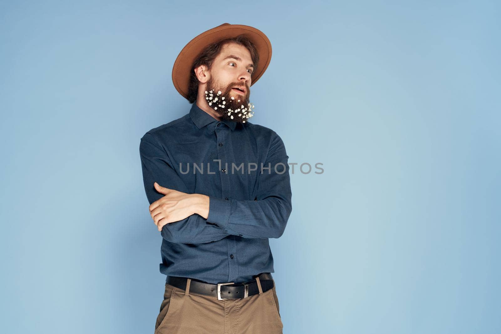 Man in flowers hat in beard emotions ecology style blue background by SHOTPRIME