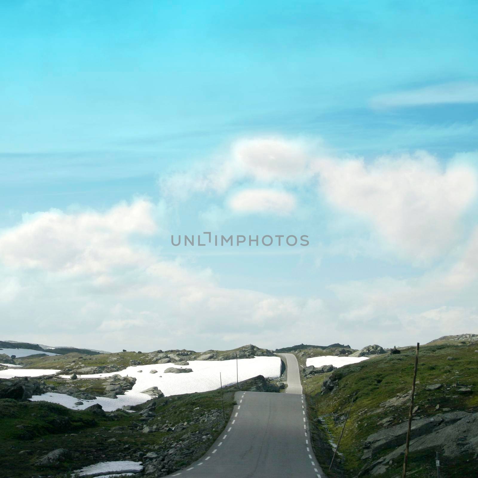 High mountain road with snowy spots