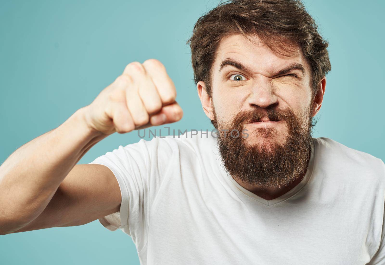 aggression stress man with a beard emotions indignant look fist. High quality photo