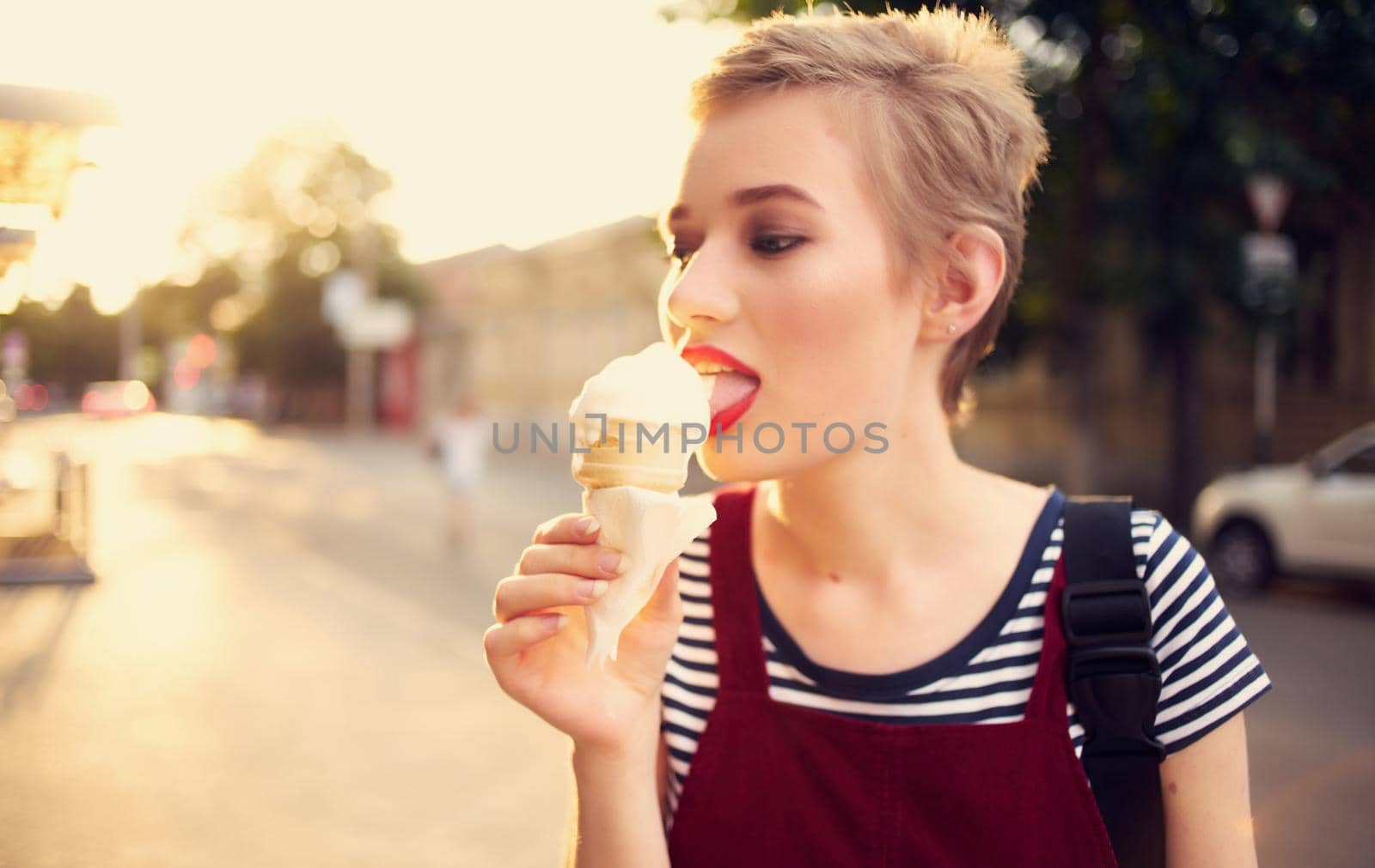 pretty woman with short hair eating ice cream outdoors leisure walk by SHOTPRIME