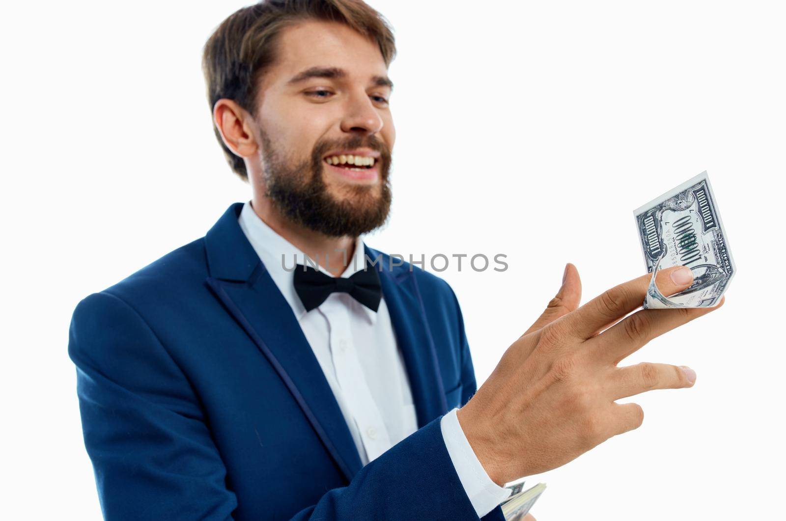 happy man with bundle of money and in classic suit on white background cropped view by SHOTPRIME