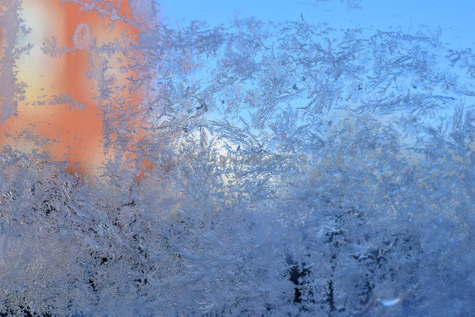 Texture as a frosty pattern on a window glass as a close-up