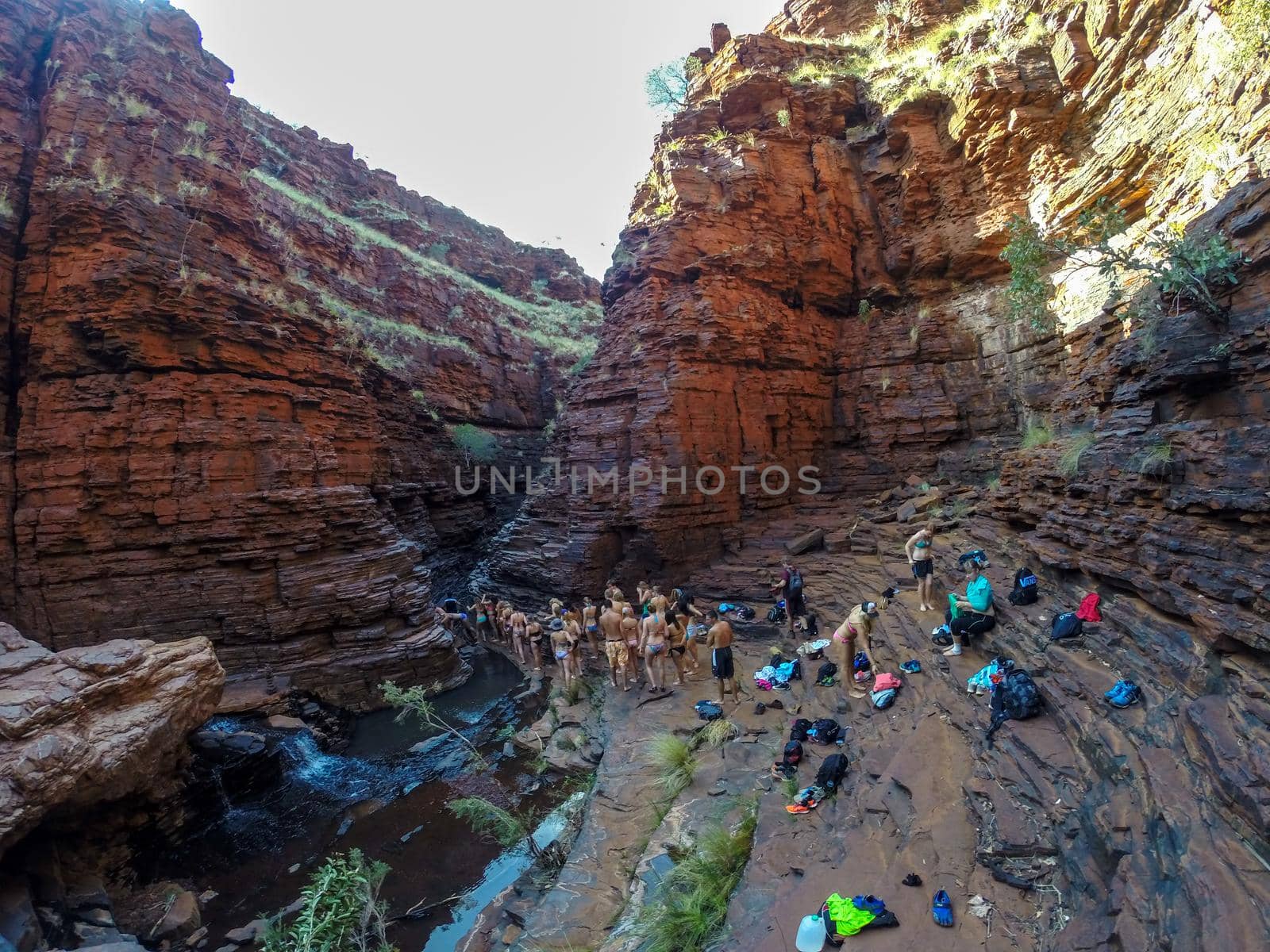 a group of tourist exploring the Handrail Pool, Weano Gorge, Karijini National Park, Western Australia by bettercallcurry