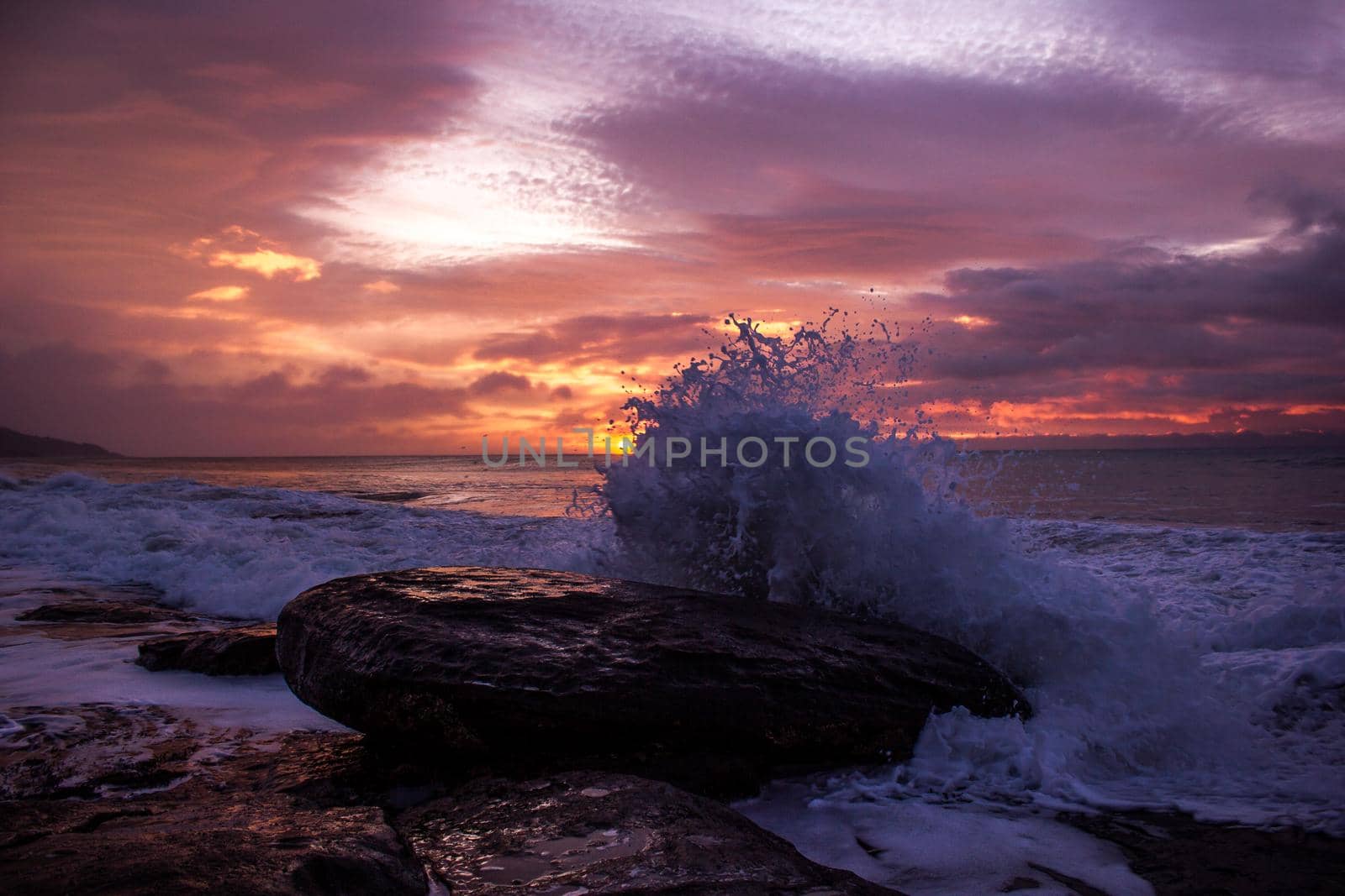 waves crushing a rock during sunrise. Sea sunrise at the great Ocean Road, Victoria