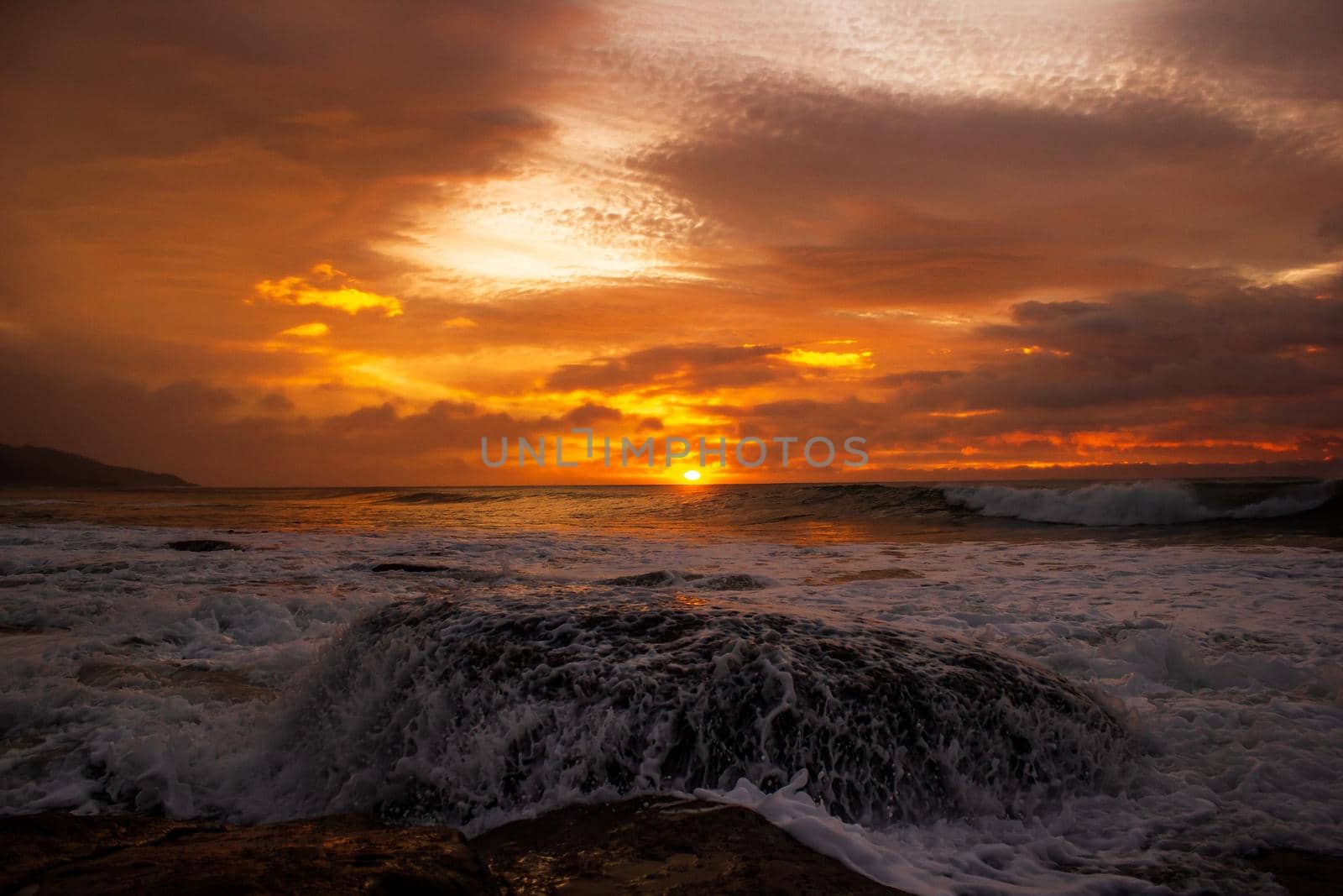 waves crushing a rock during sunrise. Sea sunrise at the great Ocean Road, Victoria