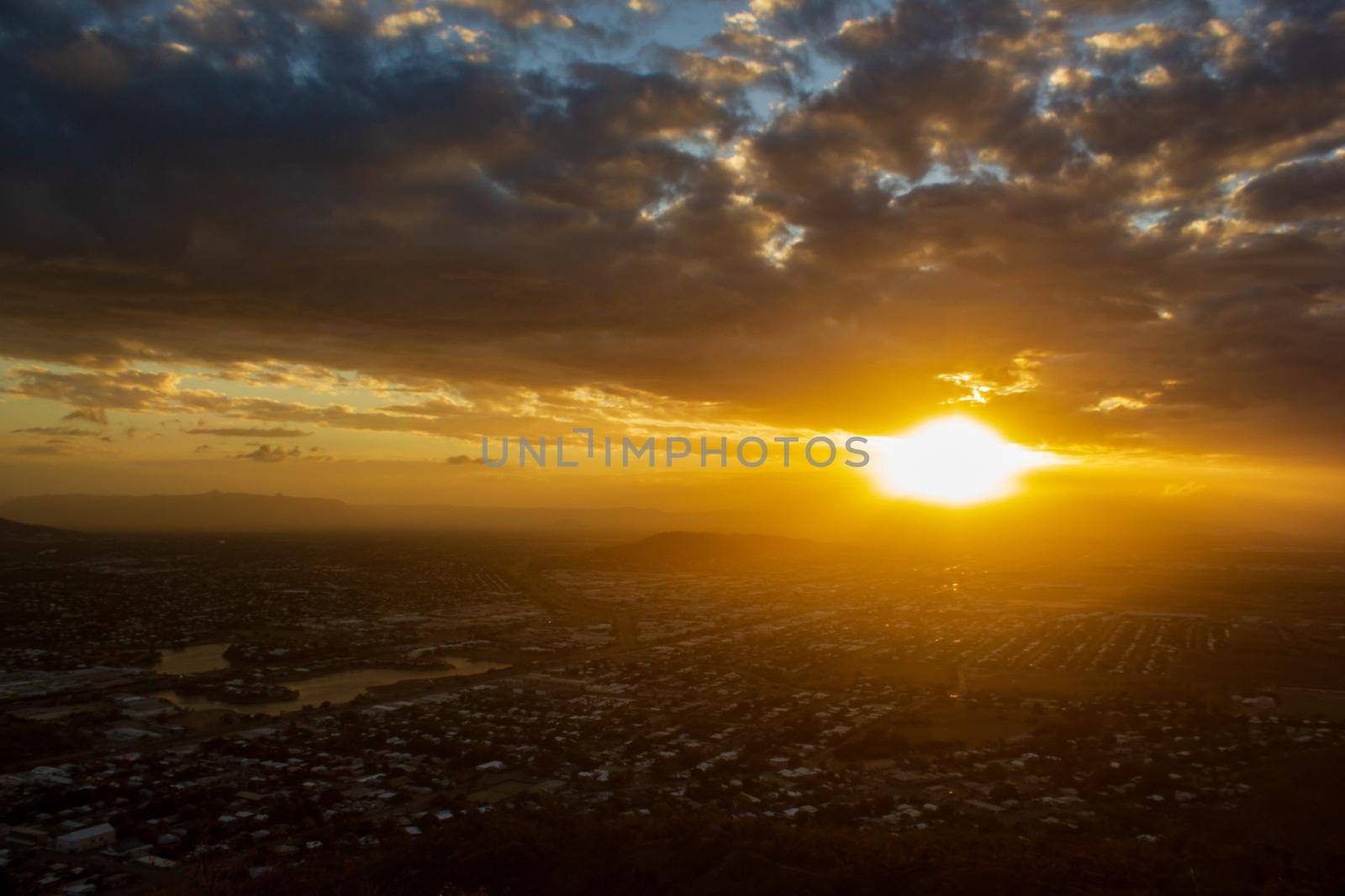 Sunset view of Townsville, Queensland, Australia looking from Castle Hill towards the coast and calm sea by bettercallcurry