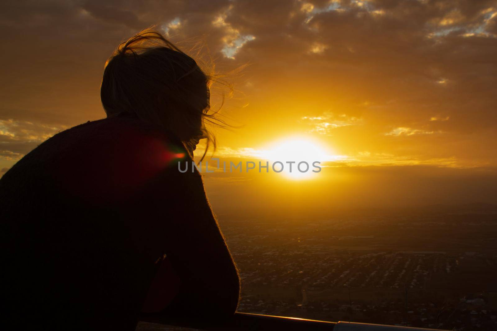young women enyoing sunset view of Townsville, Queensland, Australia looking from Castle Hill towards the coast and calm sea by bettercallcurry